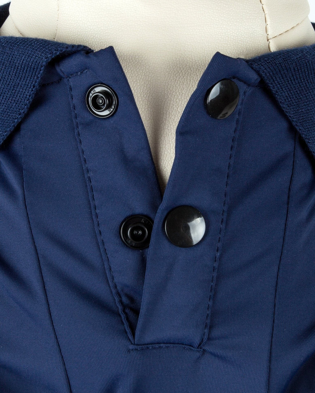 Navy dog polo close-up: snap buttons and stitched placket
