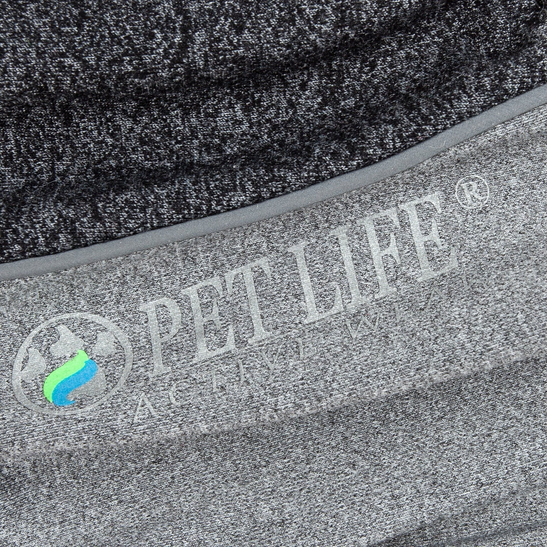 Close-up of charcoal gray fabric with printed logo on dog tracksuit side panel