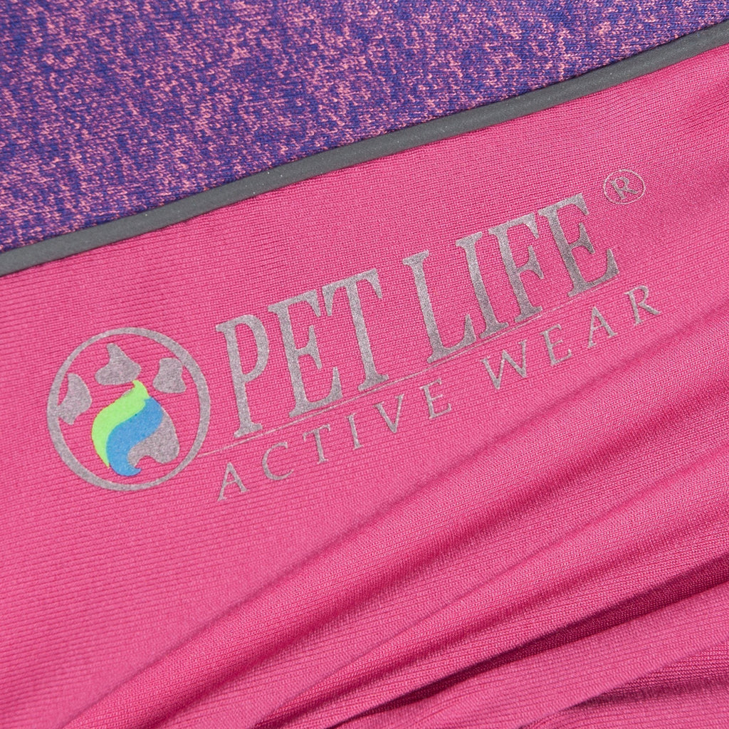 Close-up of pink fabric with printed logo on dog tracksuit inner seam panel