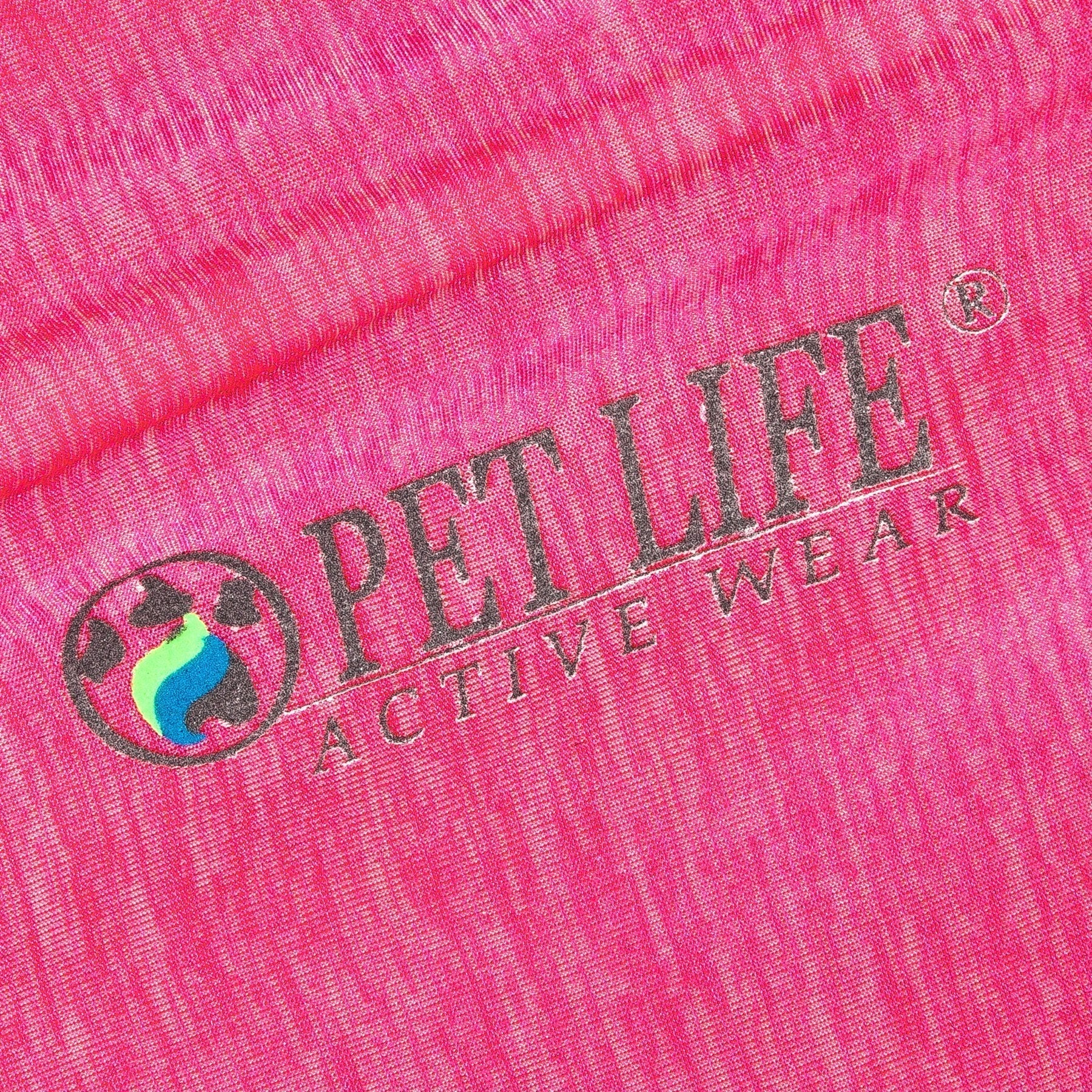 Light pink fabric close-up with printed logo on dog yoga T-shirt
