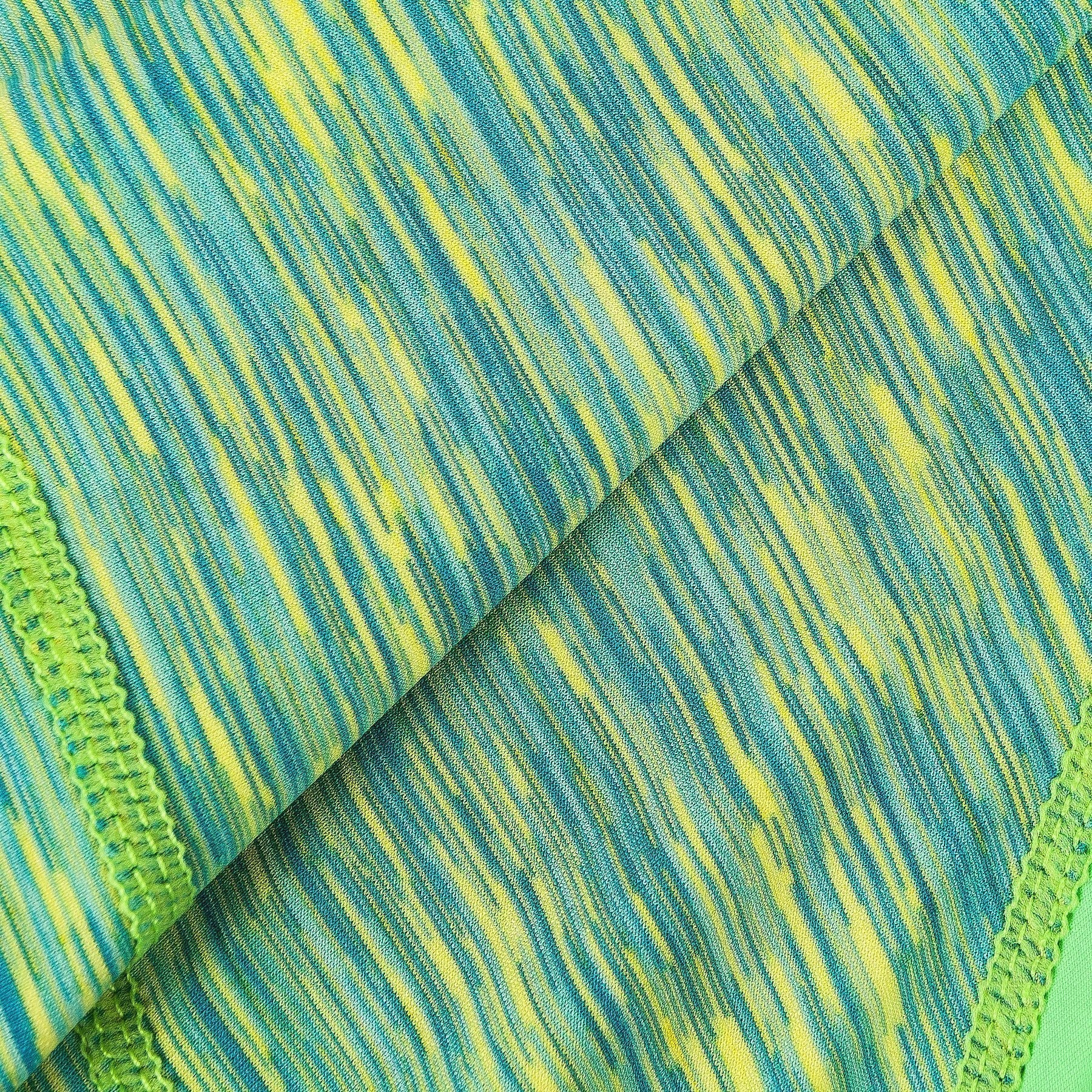 Close-up of green and teal heather stripe fabric for dog yoga tracksuit hoodie