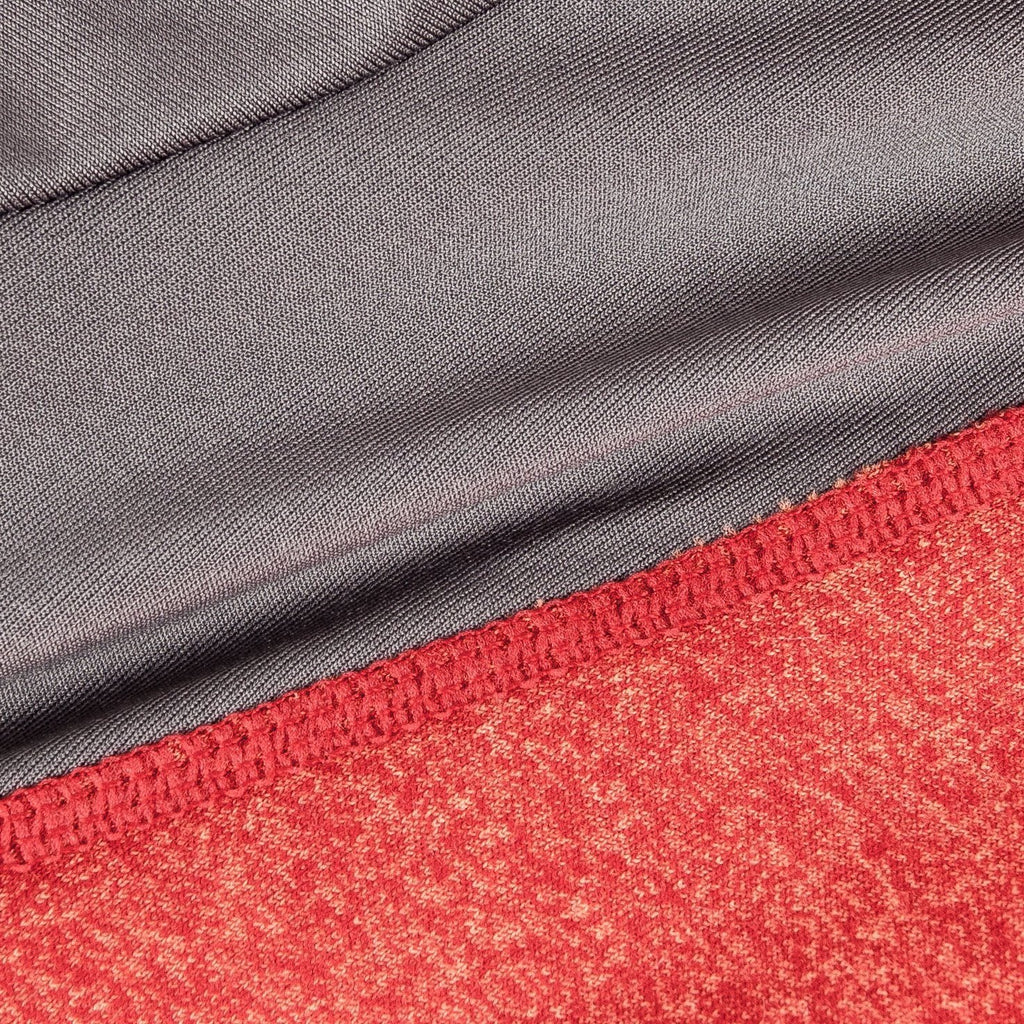 Close-up of red heather fabric with gray seam trim on a stretch dog sweater