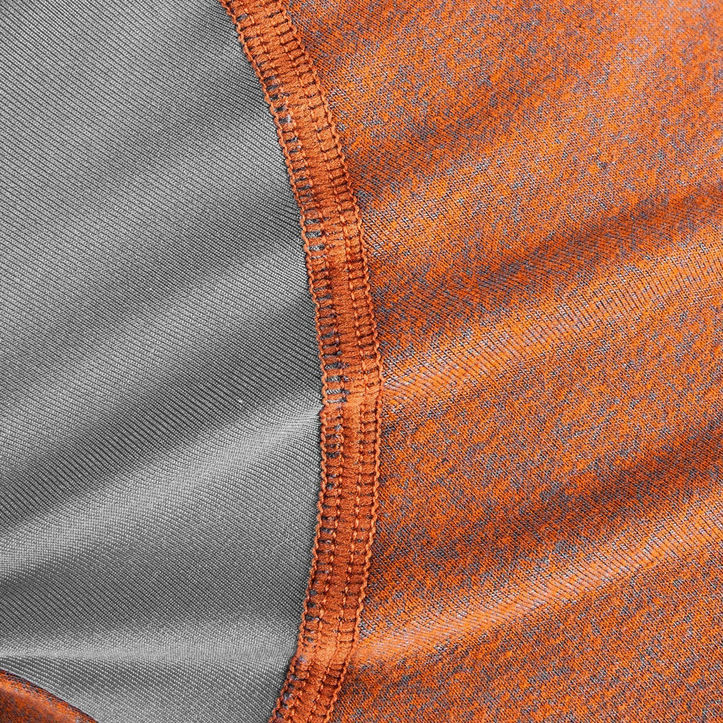Close-up of burnt orange knit panel with gray lining and orange seam stitching