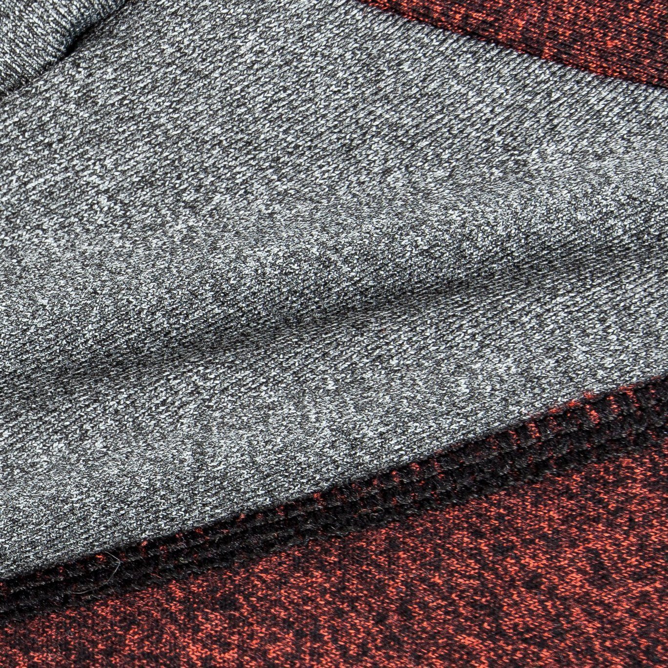 Close-up of gray heather fabric with burgundy stripe seam trim