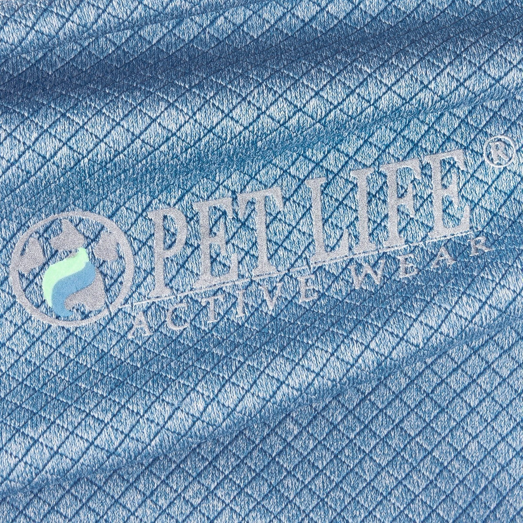 Close-up of light blue dog polo shirt fabric with PEY LIFe Active Wear logo