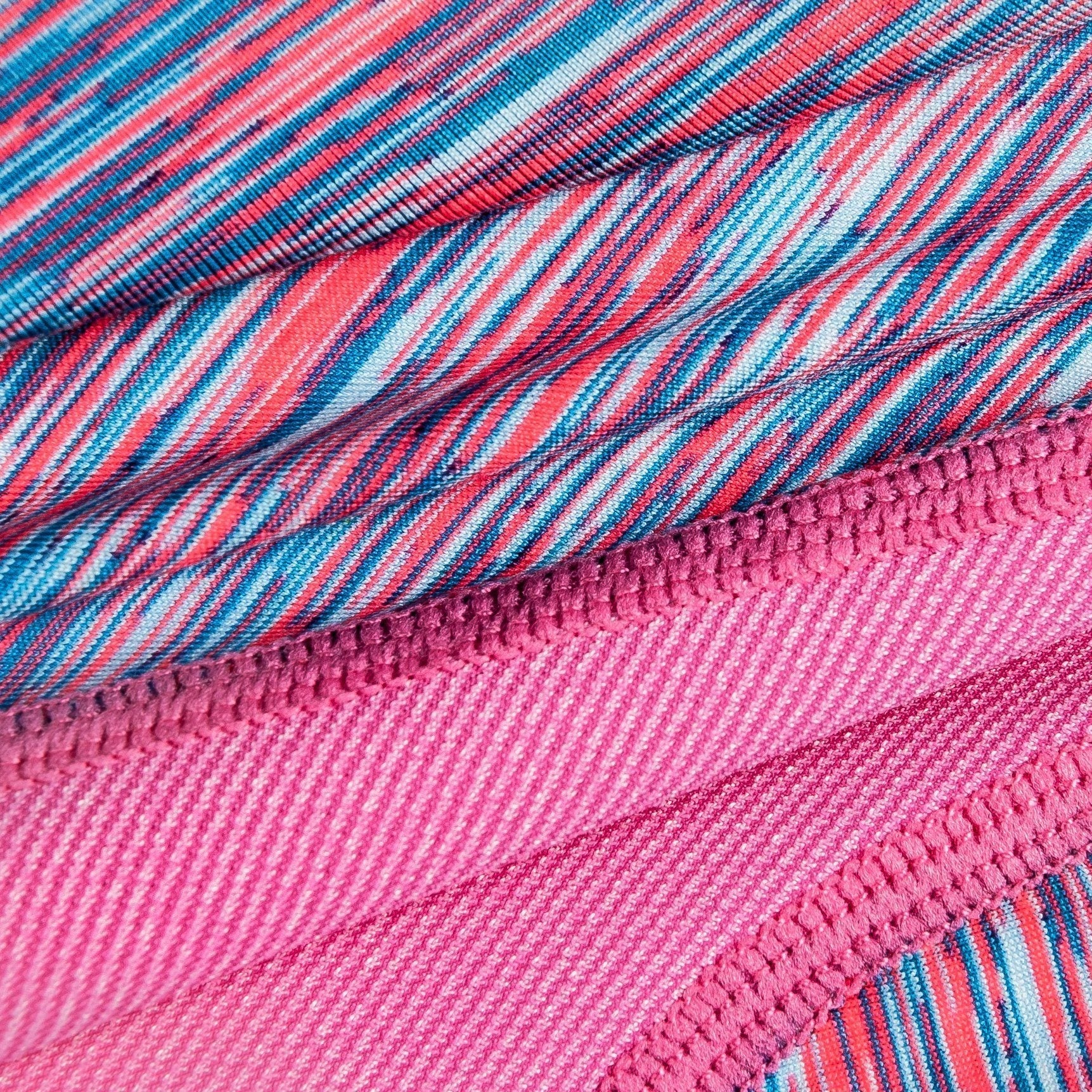 Pink-and-blue striped fabric close-up with elastic knit and stitched trim