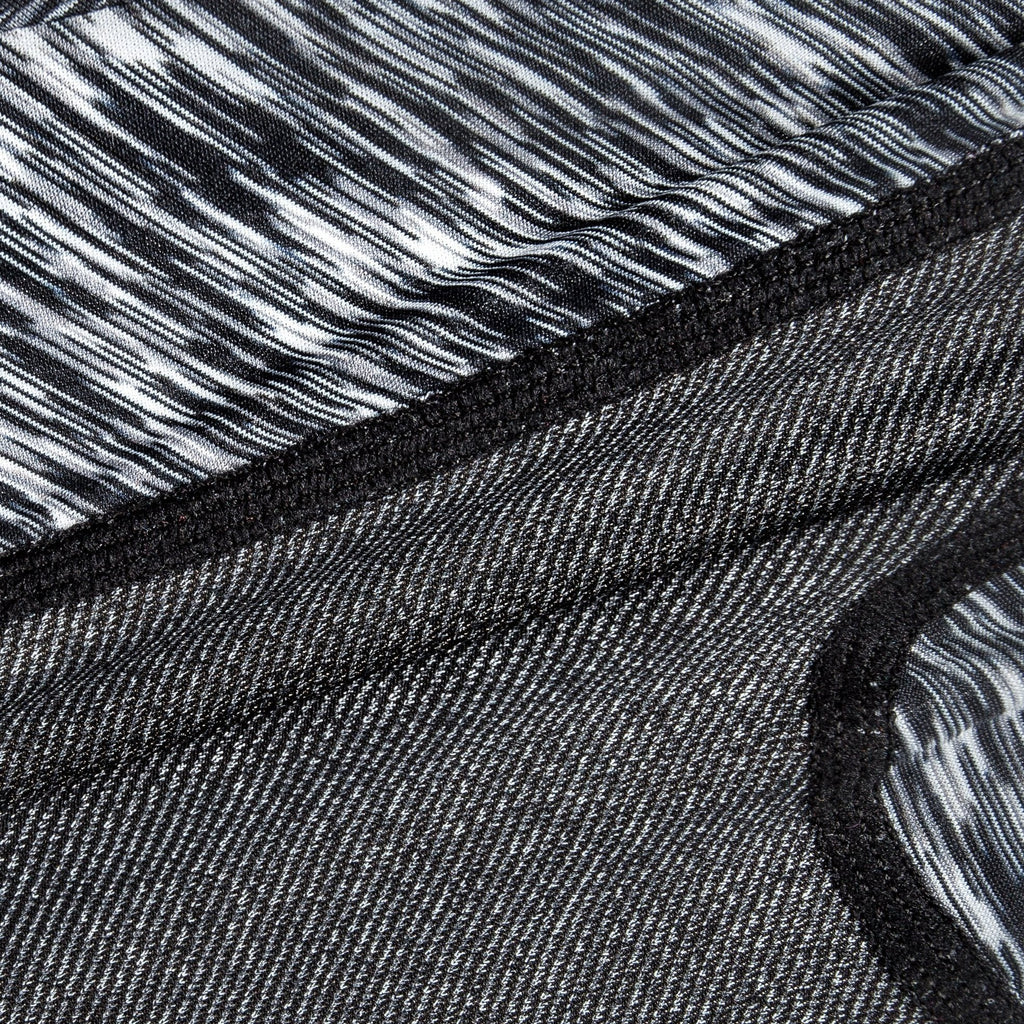 Black heather-knit fabric close-up with stitched edge and inner striped panel