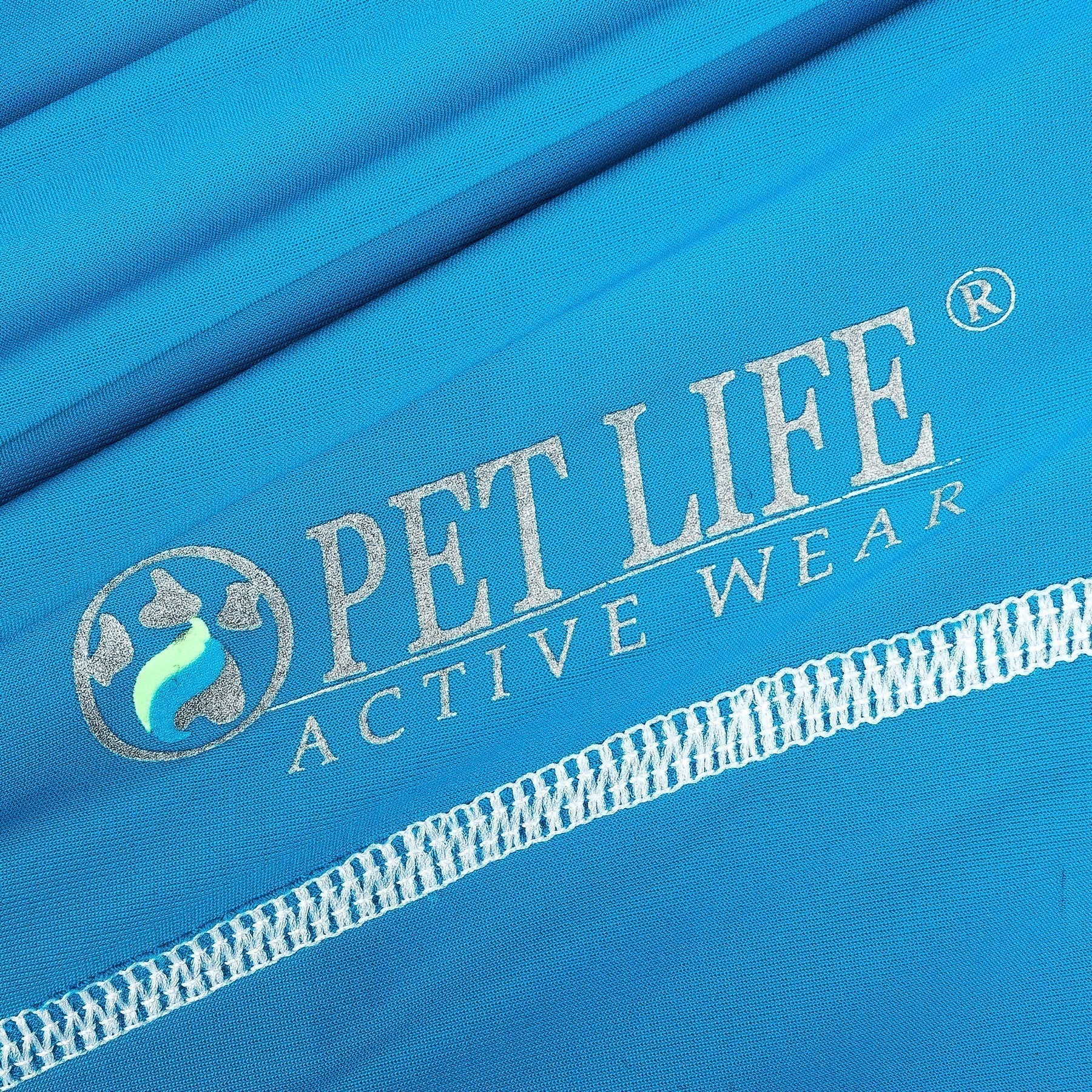Blue fabric close-up with printed logo and white trim stitching