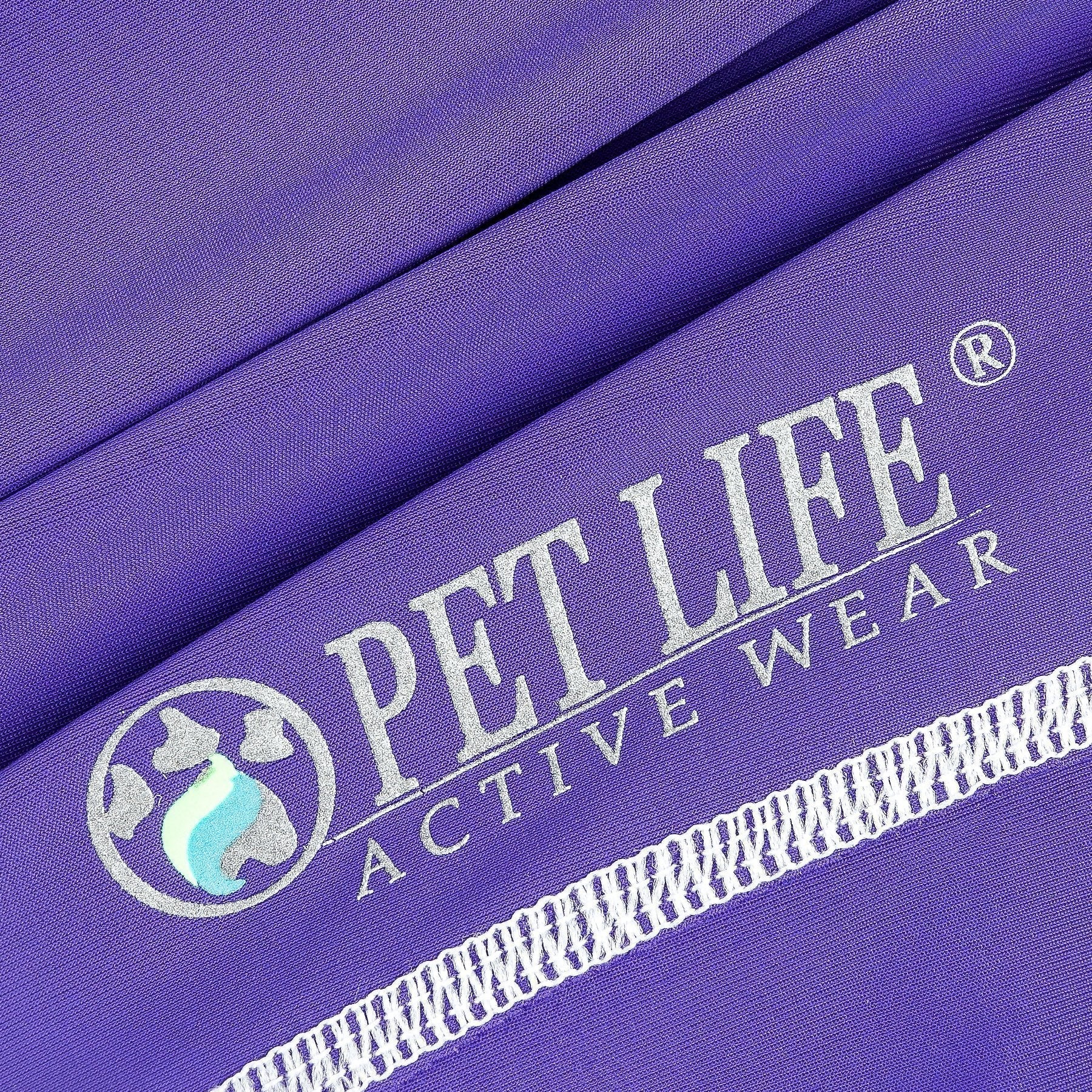 Purple fabric close-up with printed logo and white trim stitching