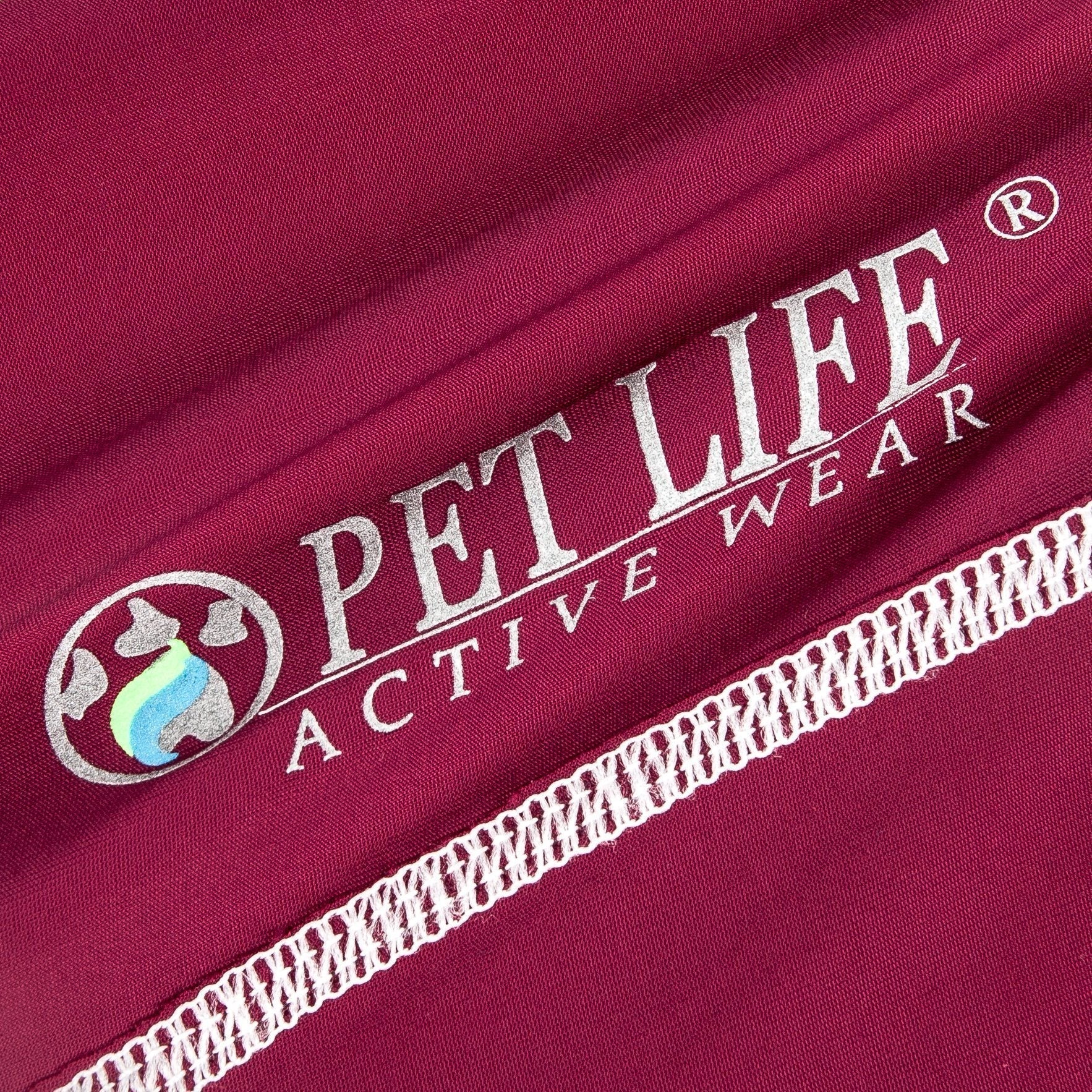 Maroon fabric close-up with printed logo and white trim stitching
