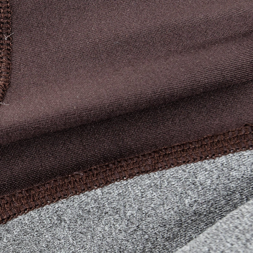 Close-up of dark brown and gray dog tracksuit fabric seam and stitching