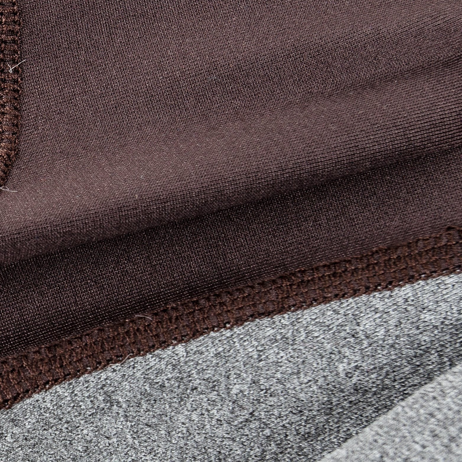 Close-up of dark brown and gray dog tracksuit fabric seam and stitching