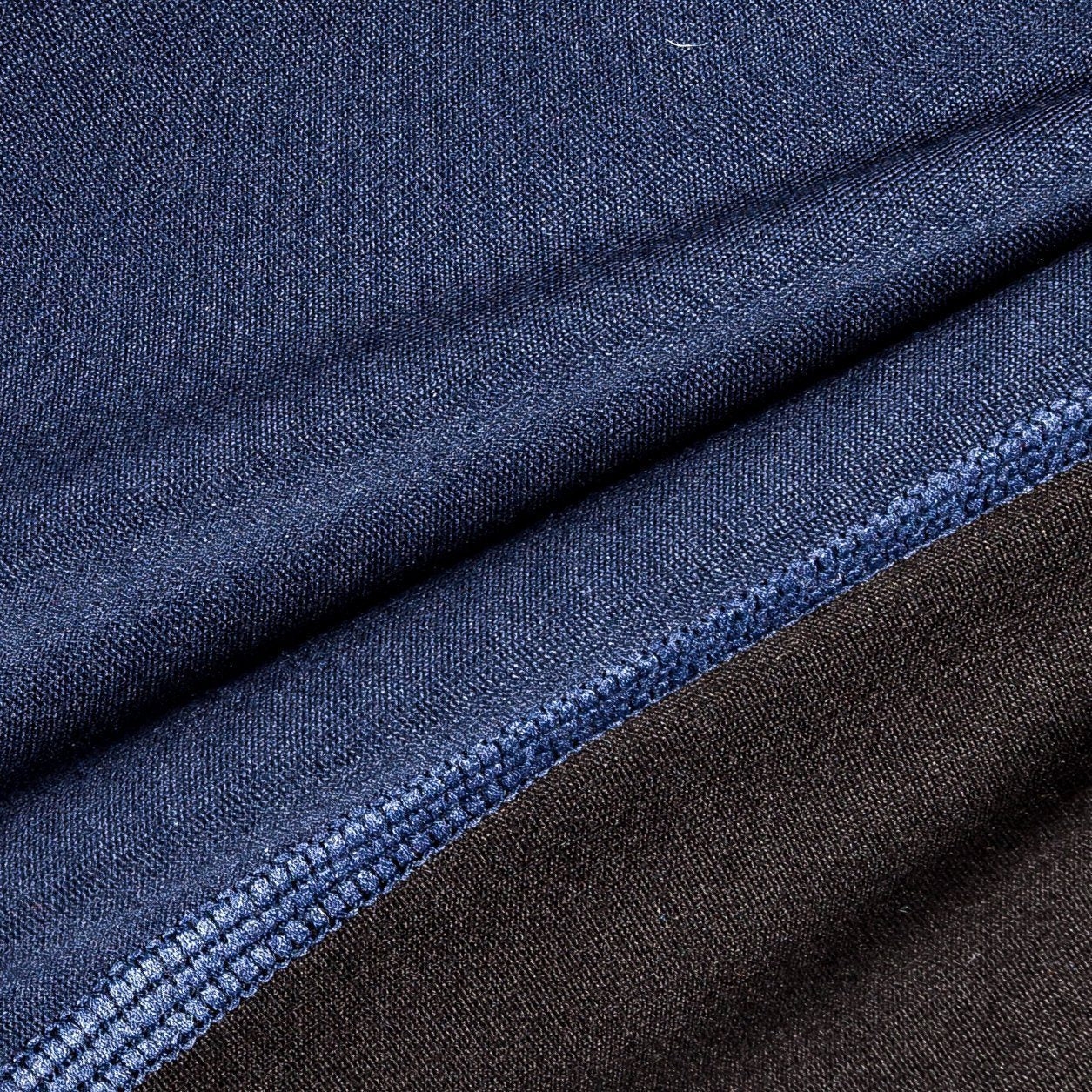 Dark blue dog yoga warm-up tracksuit fabric close-up with stitched seam