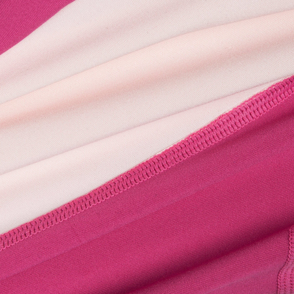 Close-up of pink and light pink dog tracksuit fabric with stitched edging
