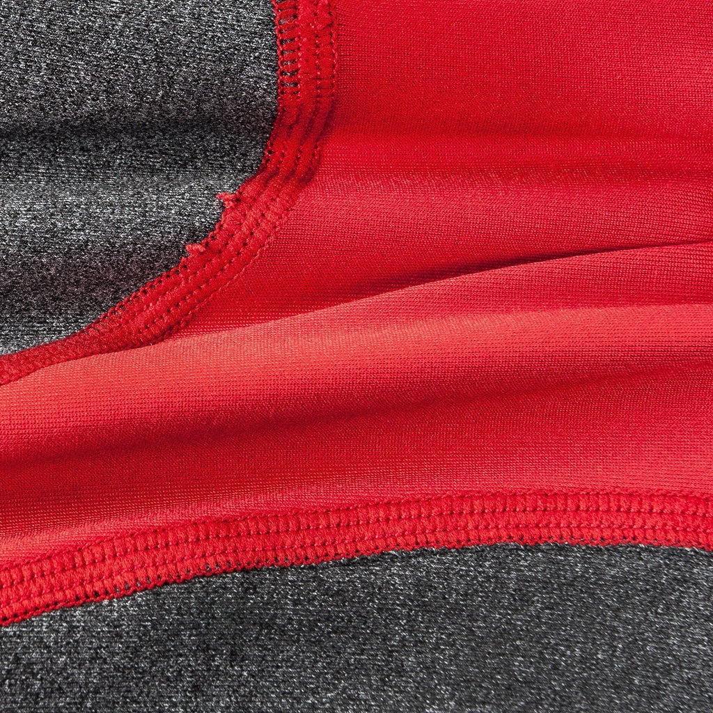 Close-up of red and dark gray dog tracksuit fabric with stitched seam detail