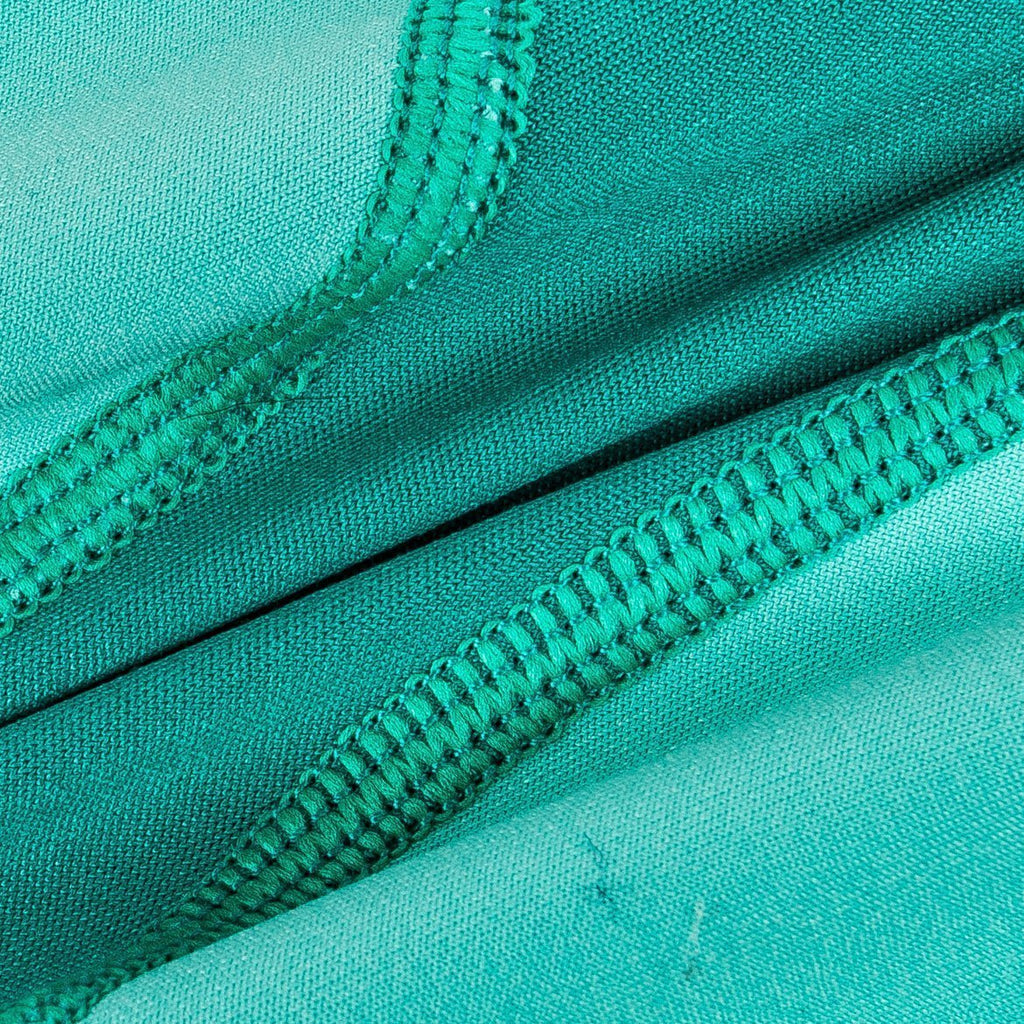 Teal green dog yoga warm-up tracksuit with seam stitching close-up