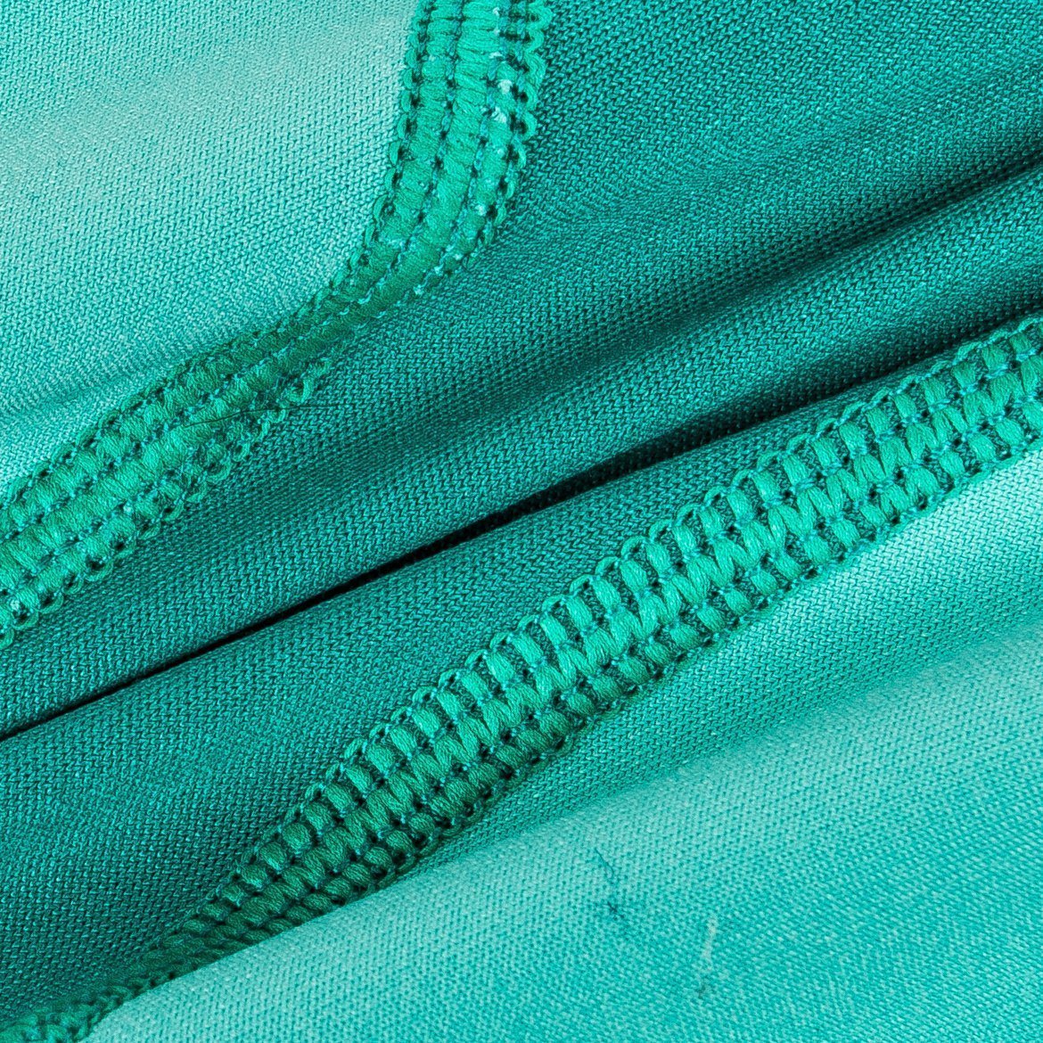 Teal green dog yoga warm-up tracksuit with seam stitching close-up