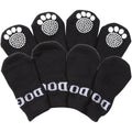Set of 4 black dog socks with white paw-print grip soles, anti-slip tread