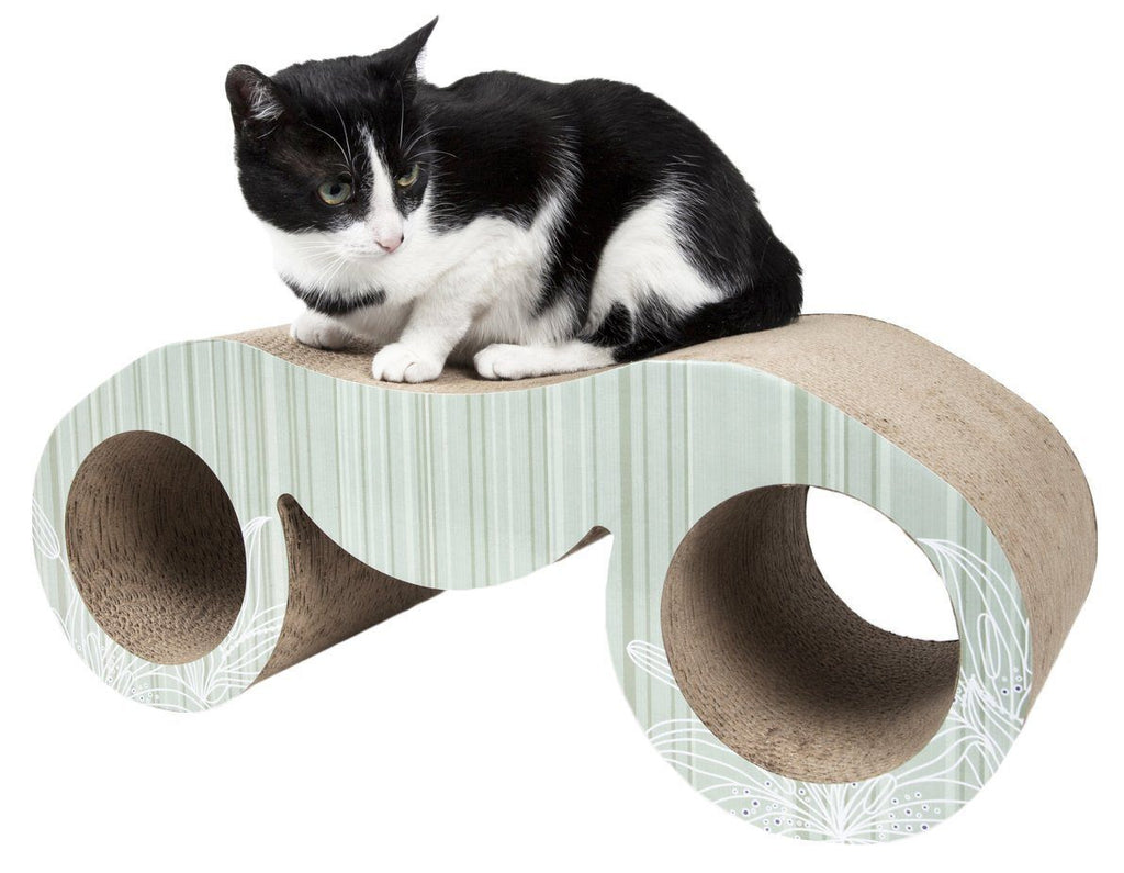 Black-and-white cat on curved cat scratcher lounger with circular side pods
