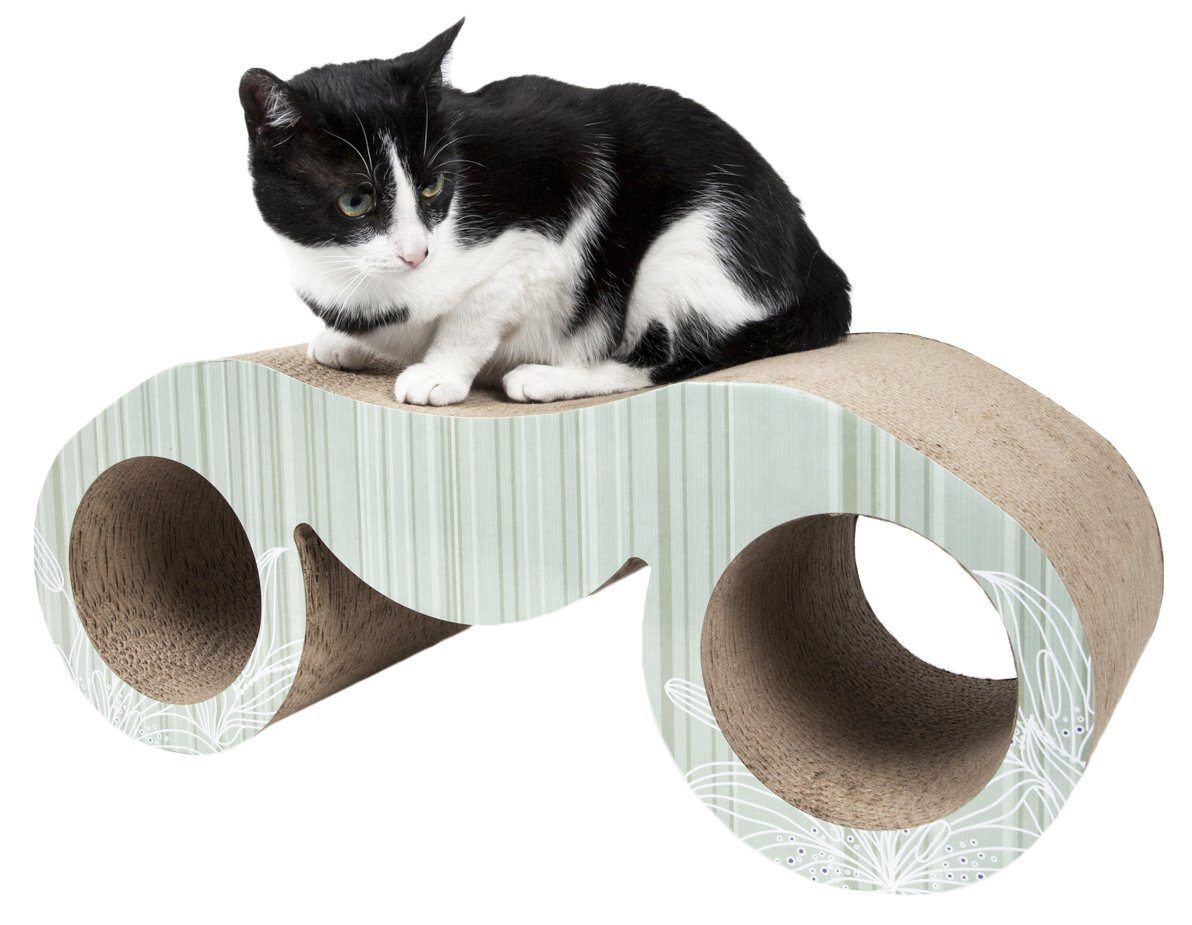 Black-and-white cat on curved cat scratcher lounger with circular side pods