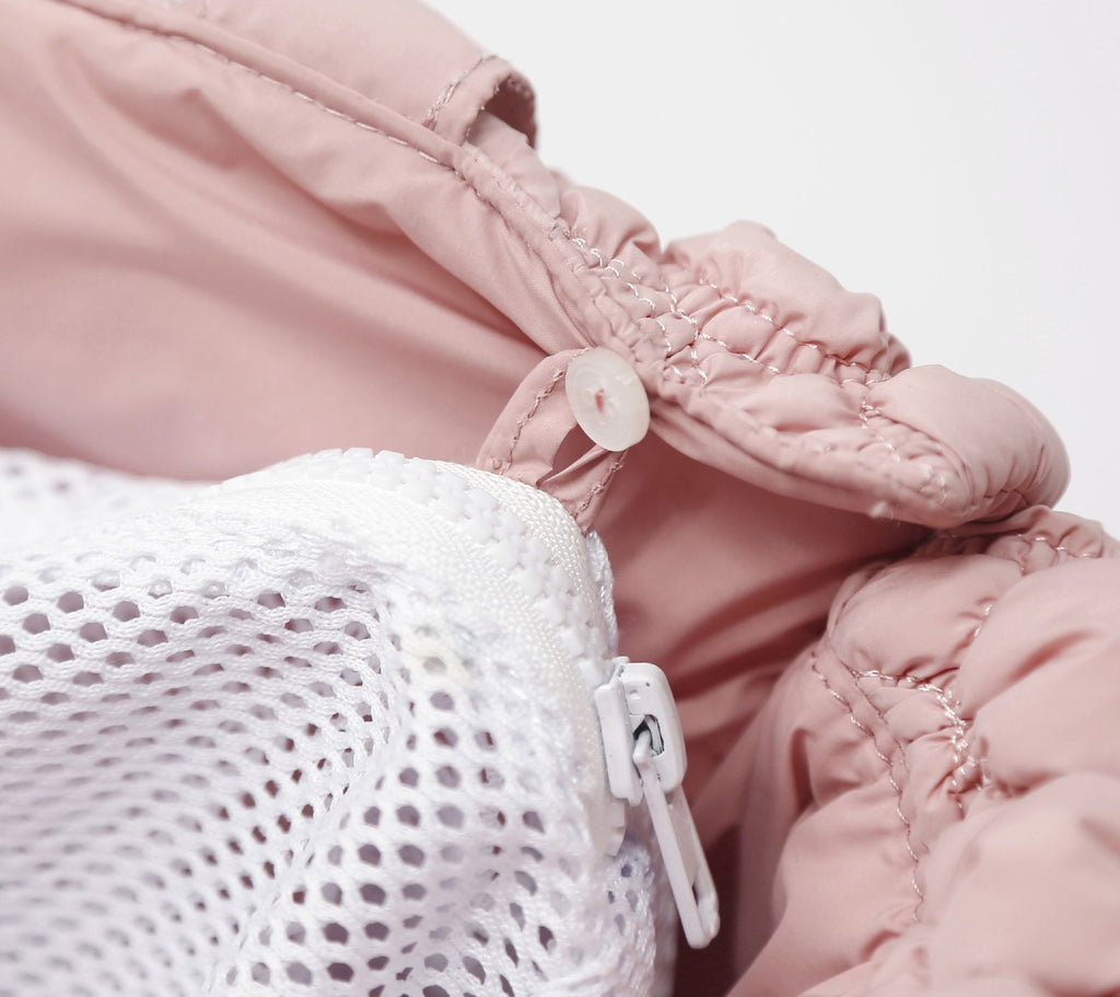 Pink plush pet carrier with mesh panel and zipper closure; close-up of opening.
