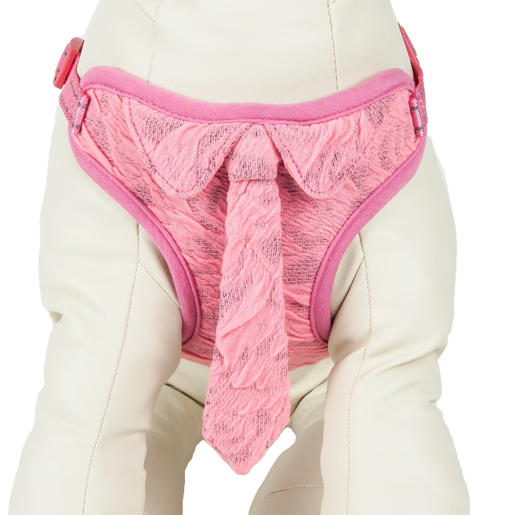 Pink reversible dog harness panel with center tie detail and adjustable straps