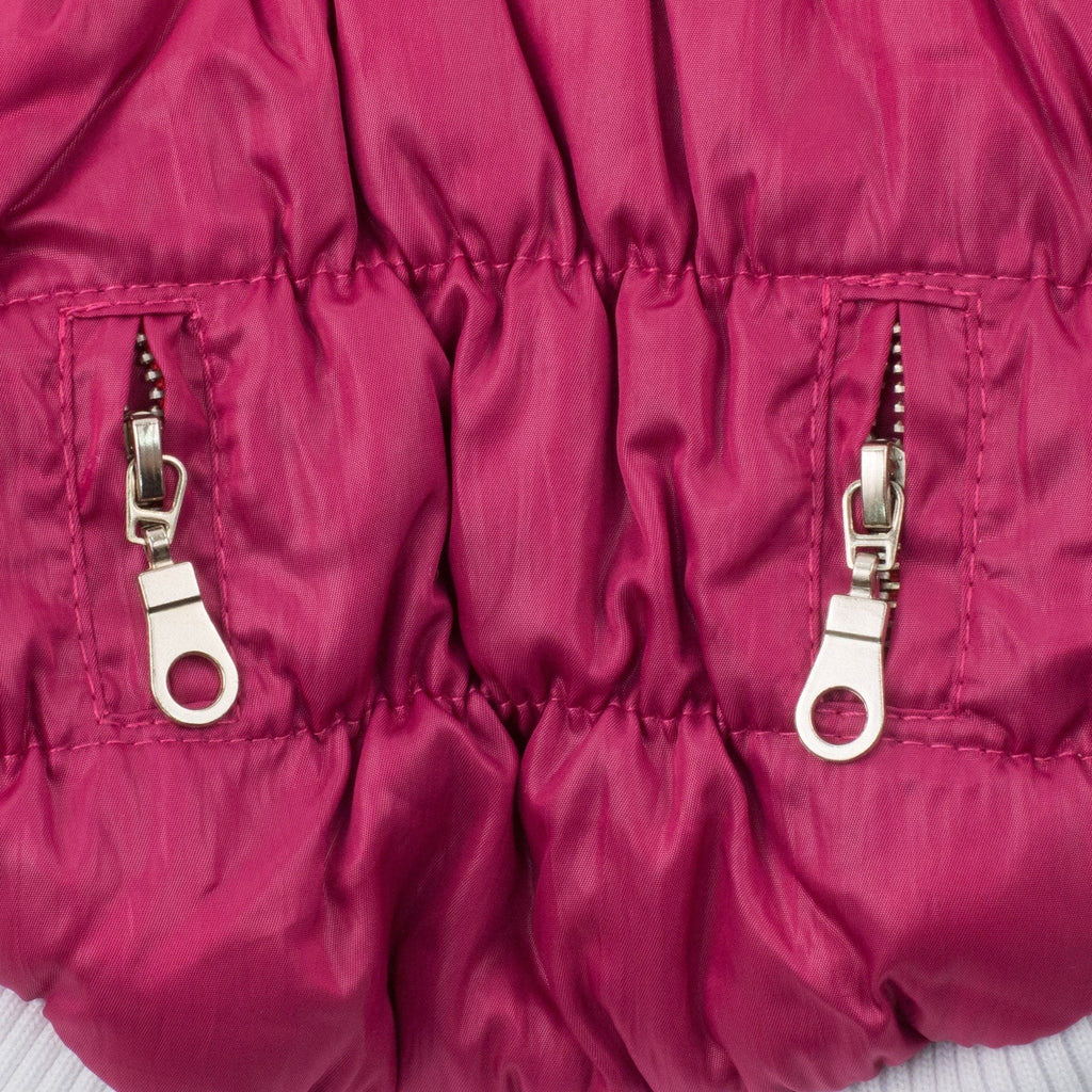 Magenta insulated dog coat side panel with two metal zipper pull accents and stitched seams
