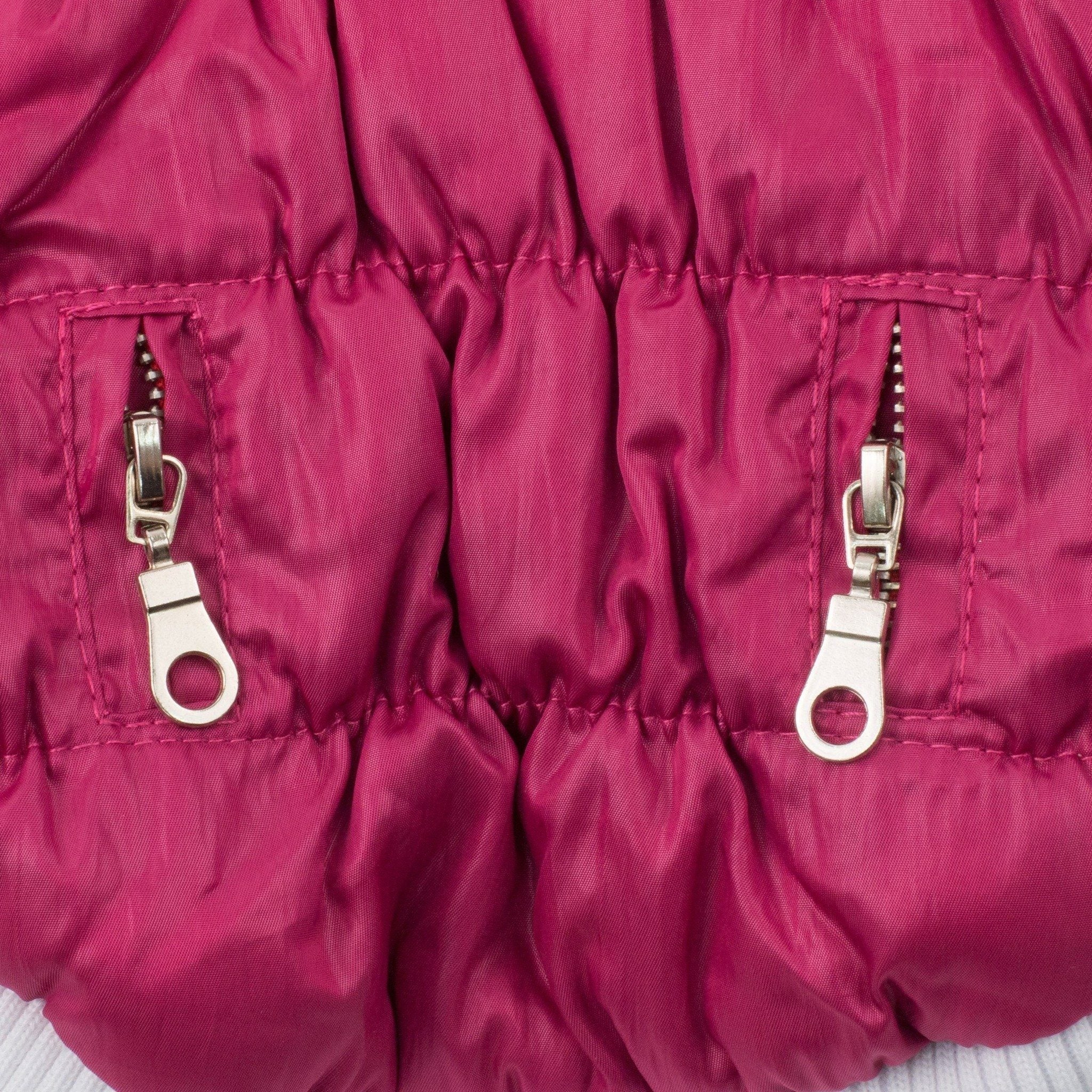 Magenta insulated dog coat side panel with two metal zipper pull accents and stitched seams