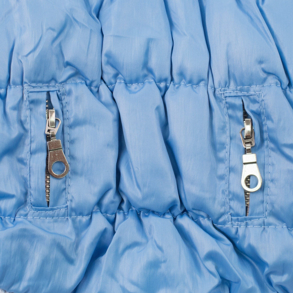 Light blue insulated dog parka side panel with two metal zipper pull accents