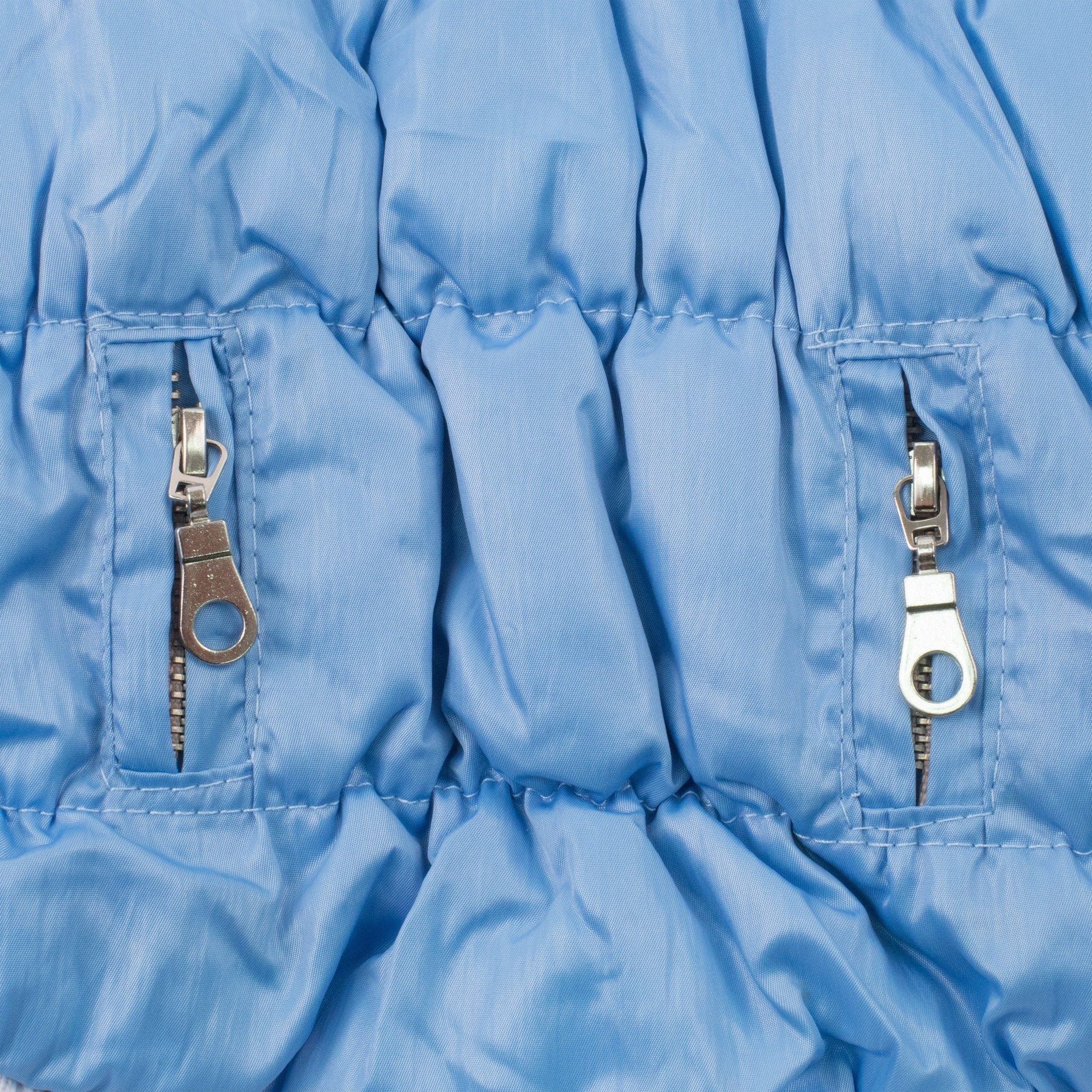Light blue insulated dog parka side panel with two metal zipper pull accents