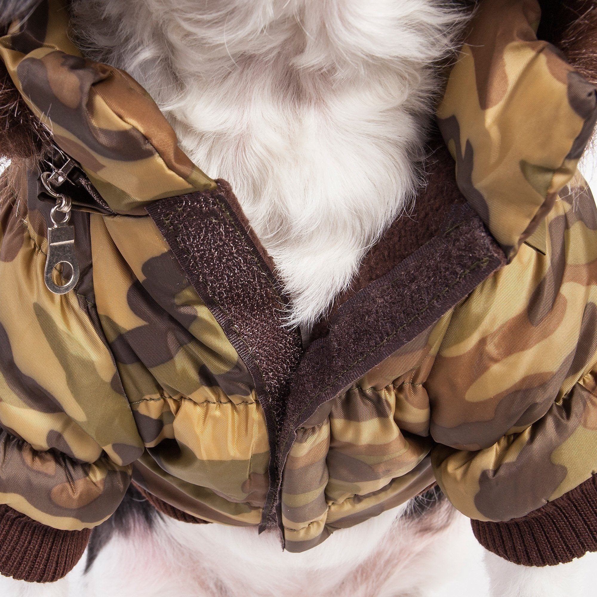 Camo-pattern insulated dog parka with removable hood and dark faux-fur trim, front close-up