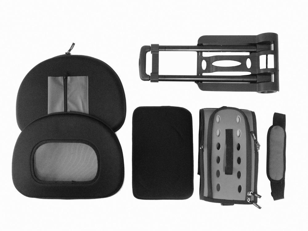 Black pet carrier parts laid out: shell, soft pad, straps, and handle frame