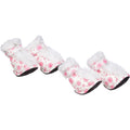 Pink & white faux-fur dog boots with round print and black tread sole, side view