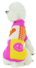 White dog sweater with pink ribbed collar, orange heart, yellow face graphic and plaid