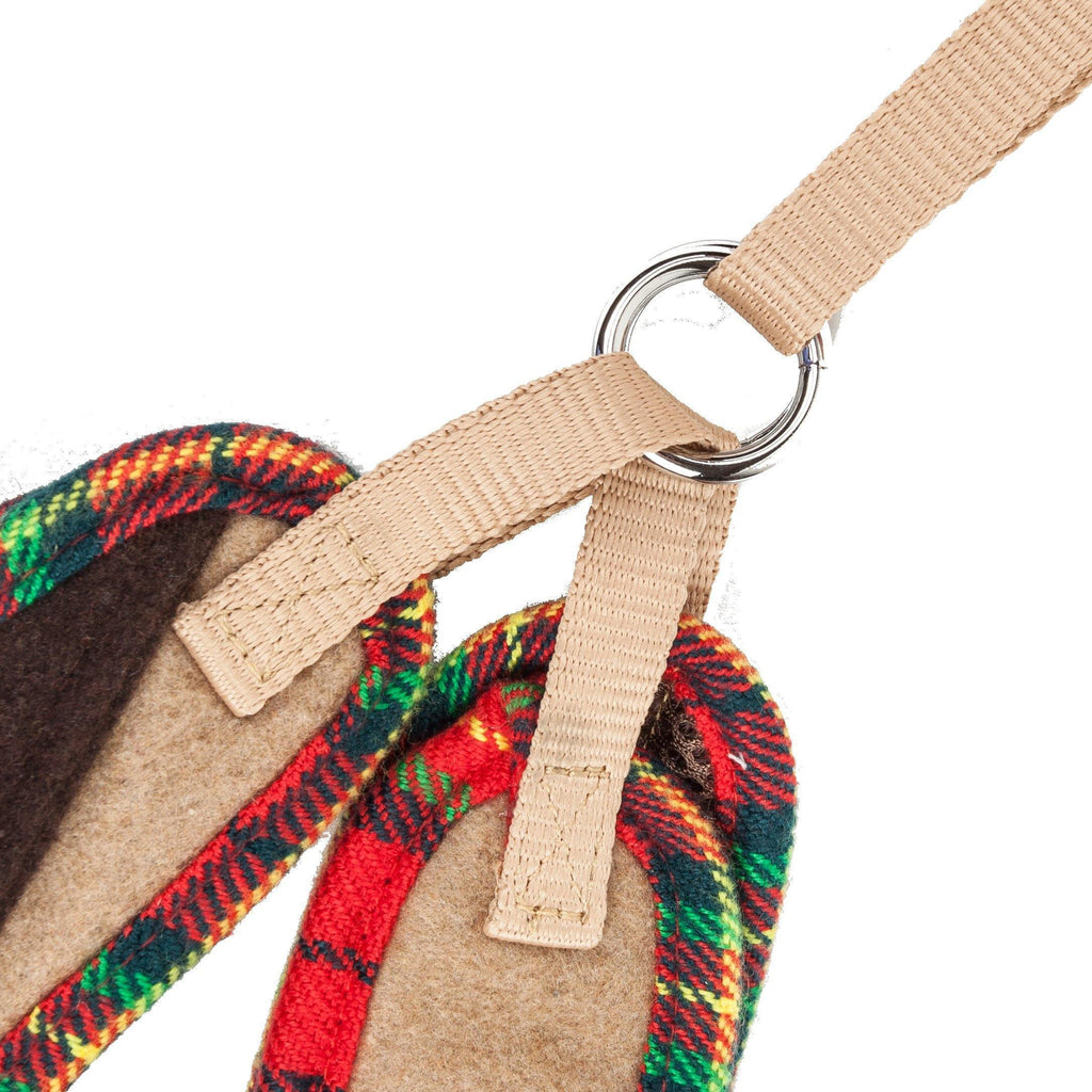 Close-up of tan leash attachment with metal ring to plaid-trim harness