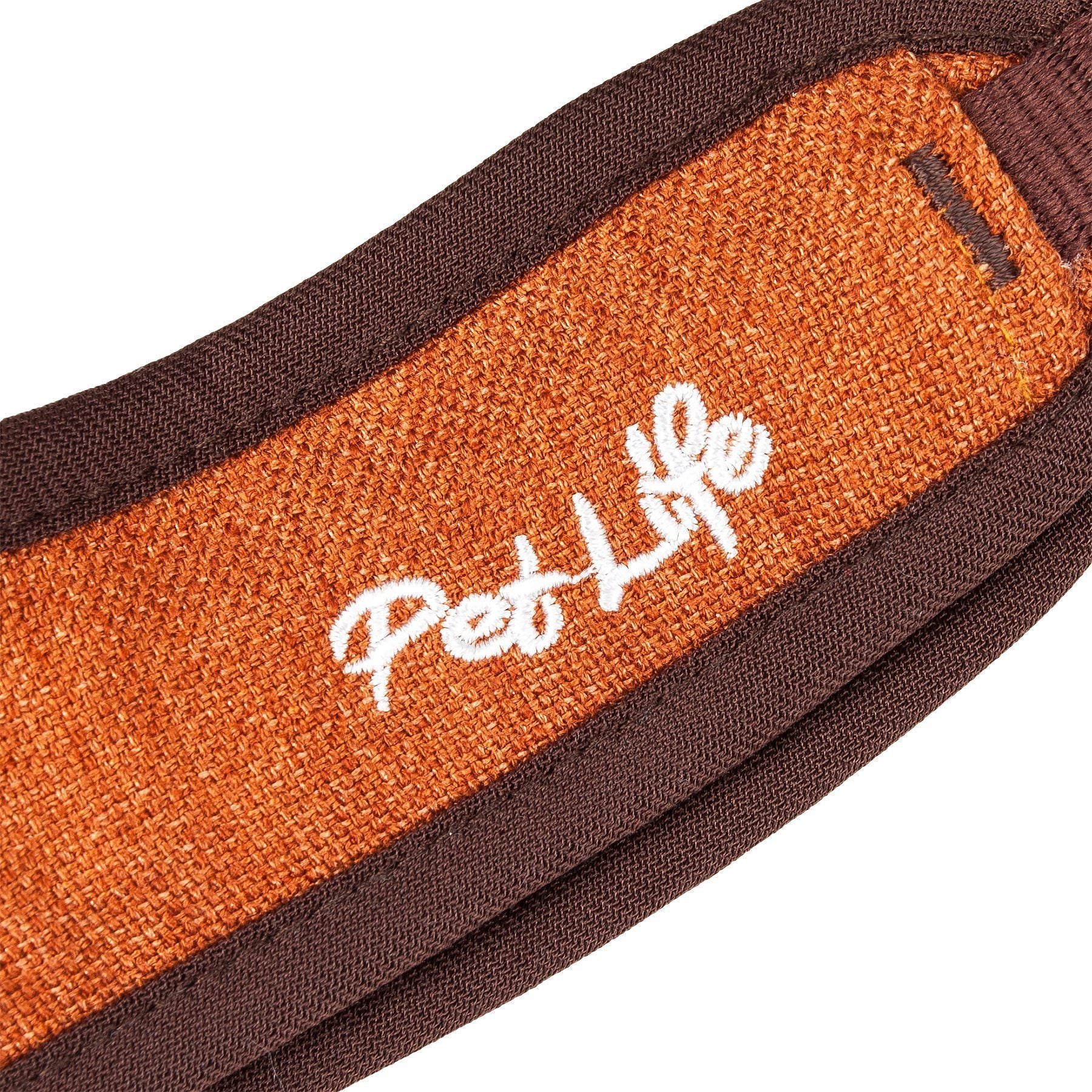 Dog leash close-up of orange-brown strap with white Paw logo and dark trim edges.