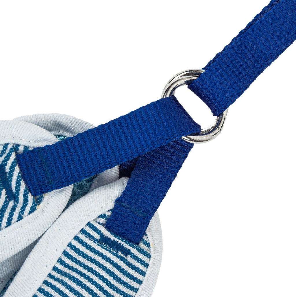 Close-up of blue dog harness strap with metal rings and striped fabric panel
