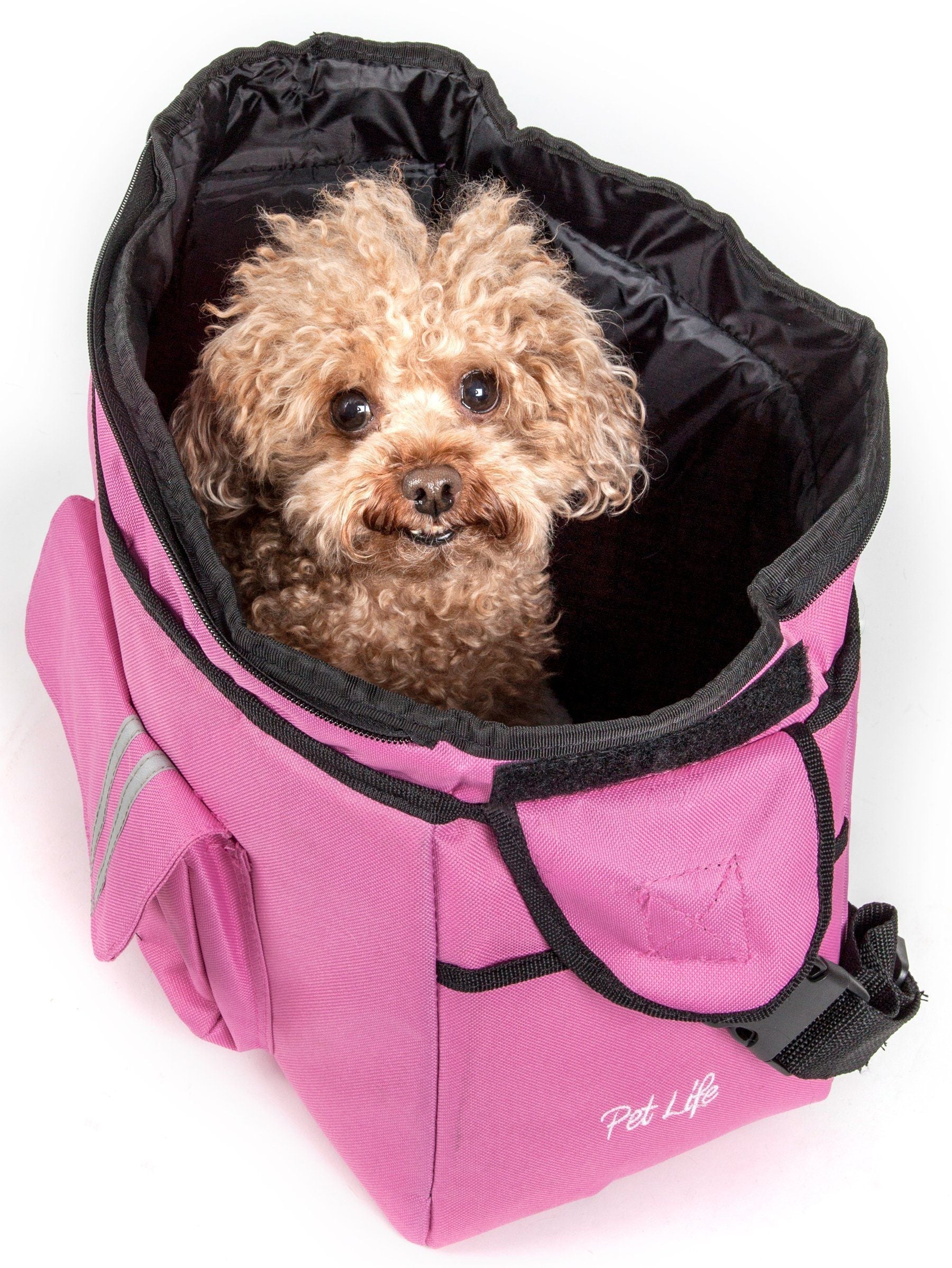 Pink over-the-shoulder dog carrier with black trim and padded rim; dog inside