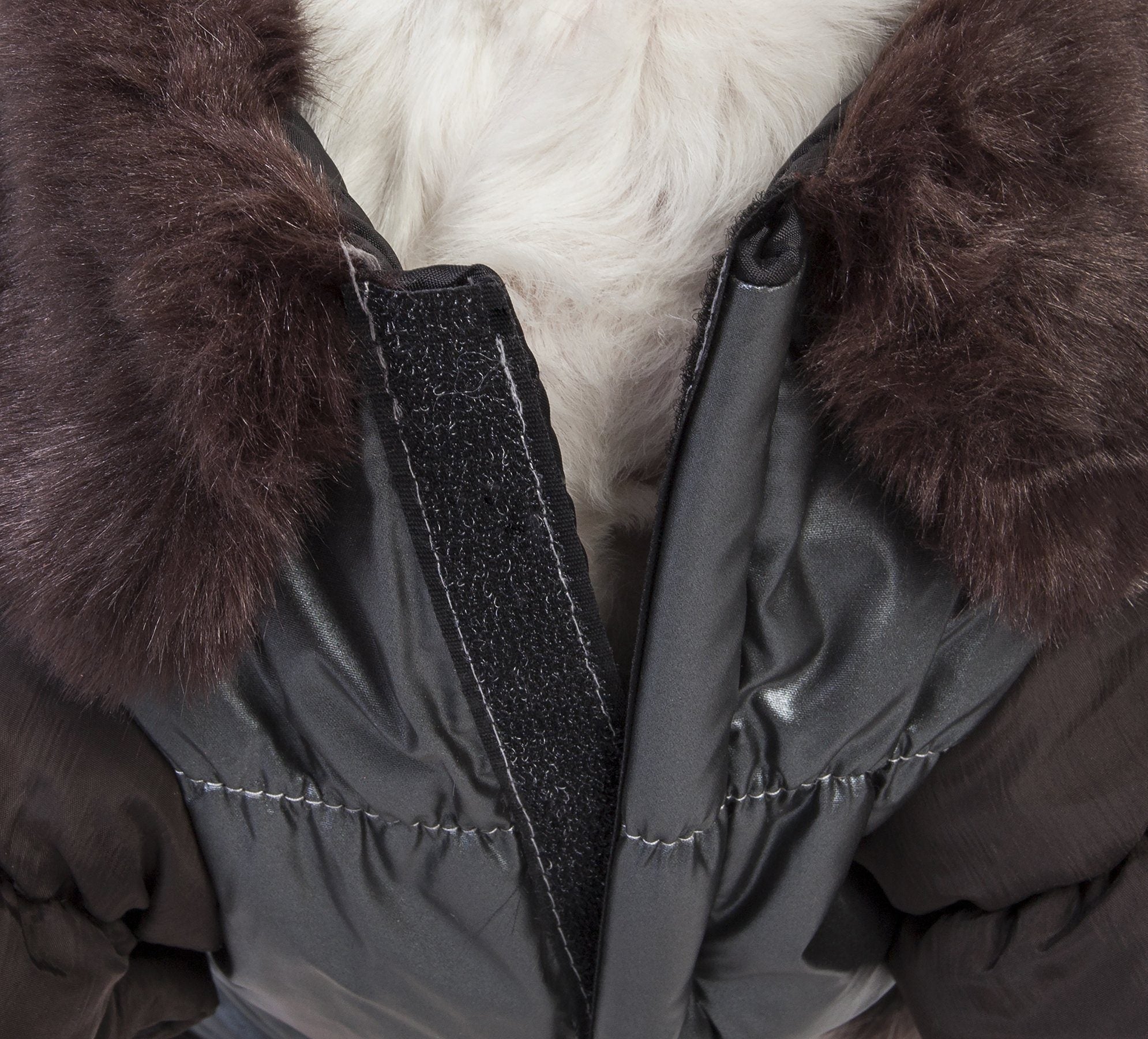 Close-up of brown faux-fur track collar on dark insulated dog jacket