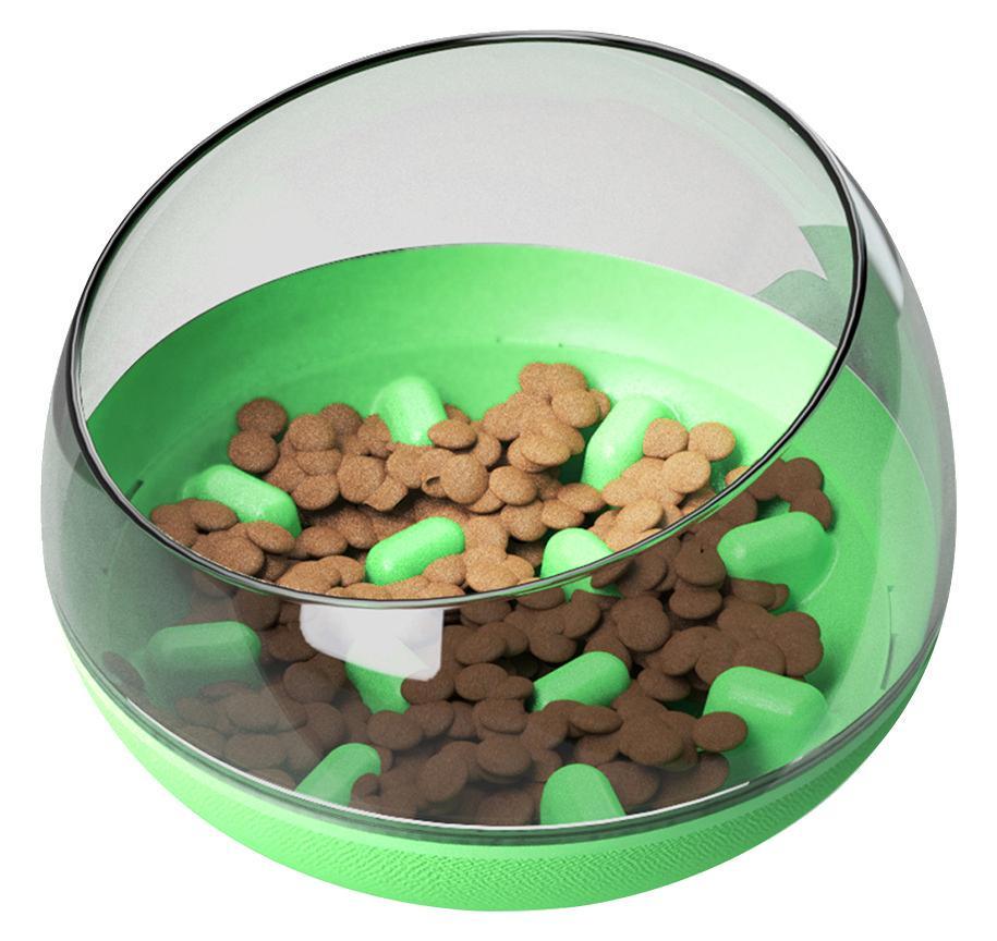 Slow feeding pet bowl close-up: clear dome, green base, kibble and green feeding bumps inside