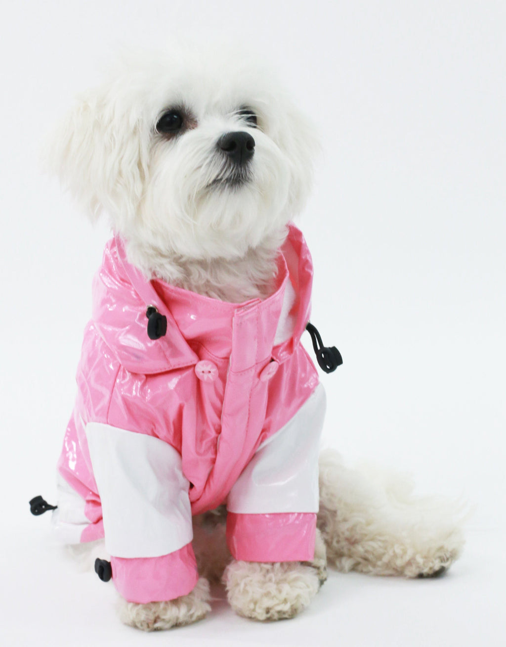 Pink and white dog raincoat with hood, black chest toggles, and button-front