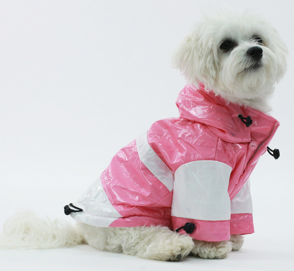 Pink & white waterproof dog raincoat with adjustable chest toggles and leg strap closures