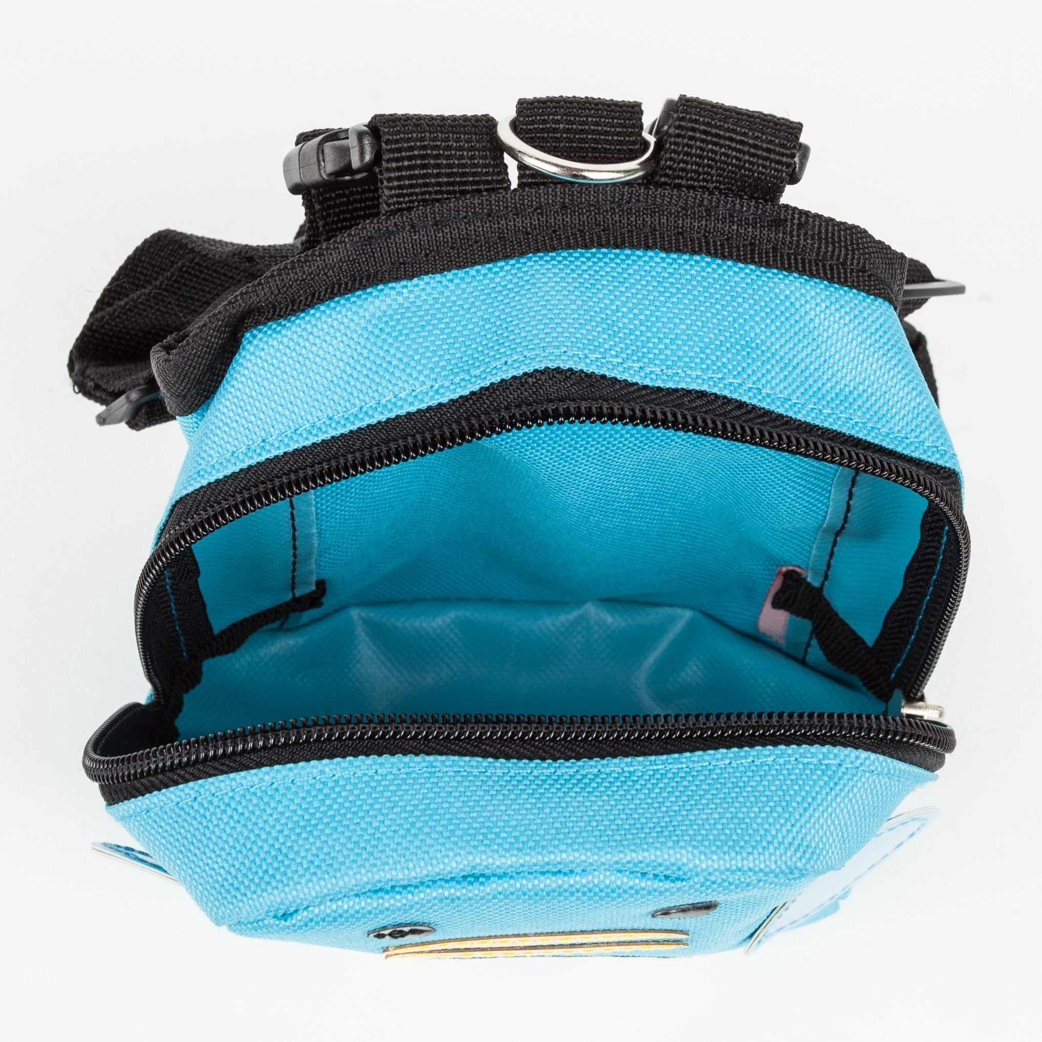 Top view of blue dog harness backpack with open zipper and black interior webbing