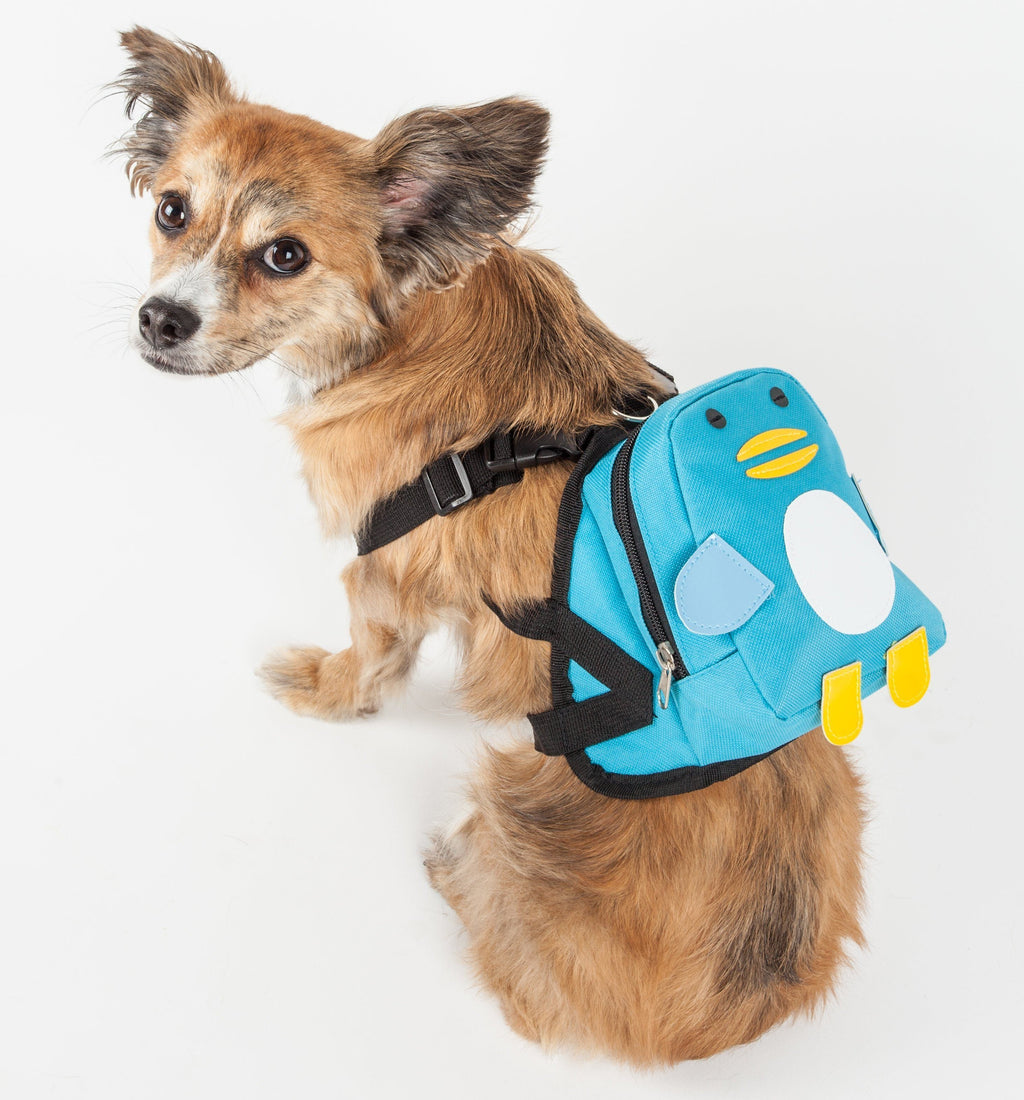 Dog wearing blue animated pocket harness backpack with waggler face and black straps