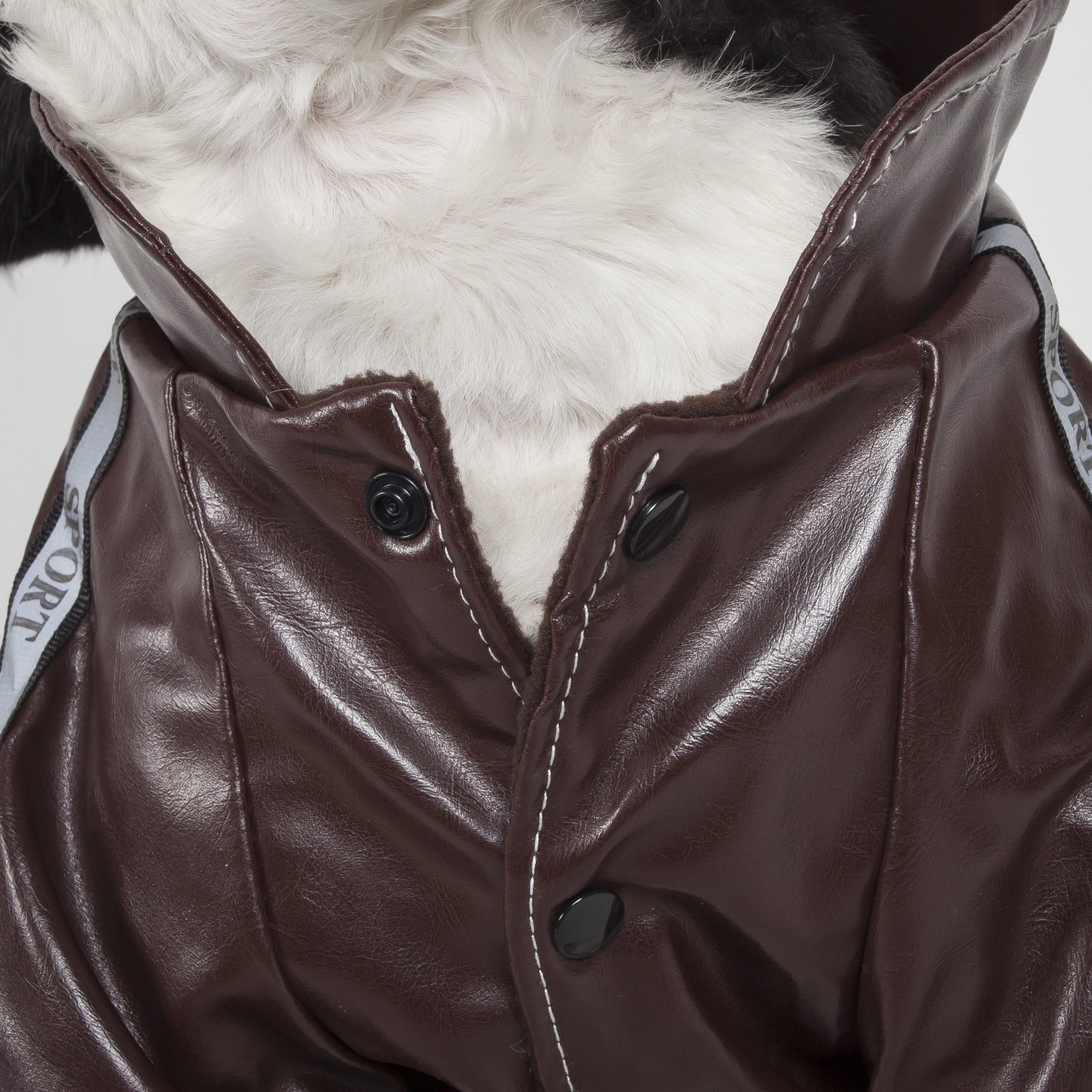 Close-up brown dog jacket front with snap buttons and stitched V yoke