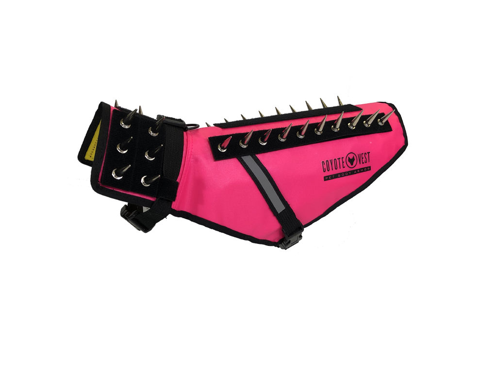 Neon pink pet vest with black spikes, D-ring leash clip, and adjustable straps
