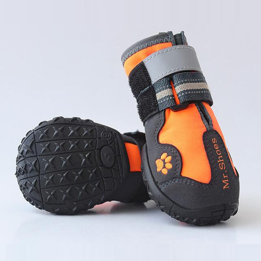 Orange and black waterproof dog boots with paw logo and gray hook-and-loop strap