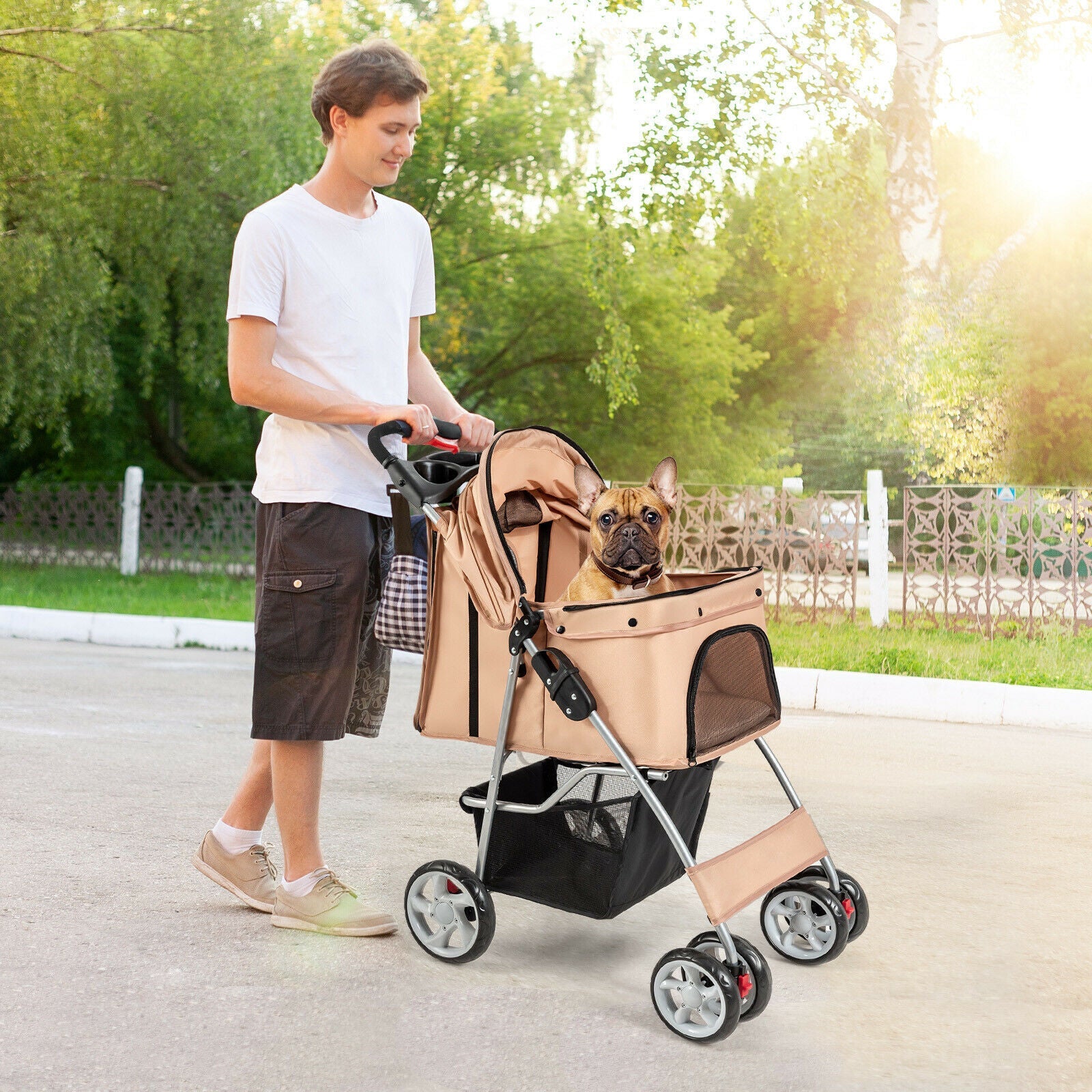 Beige pet stroller with 4 wheels and mesh sides, carrying a small dog inside.