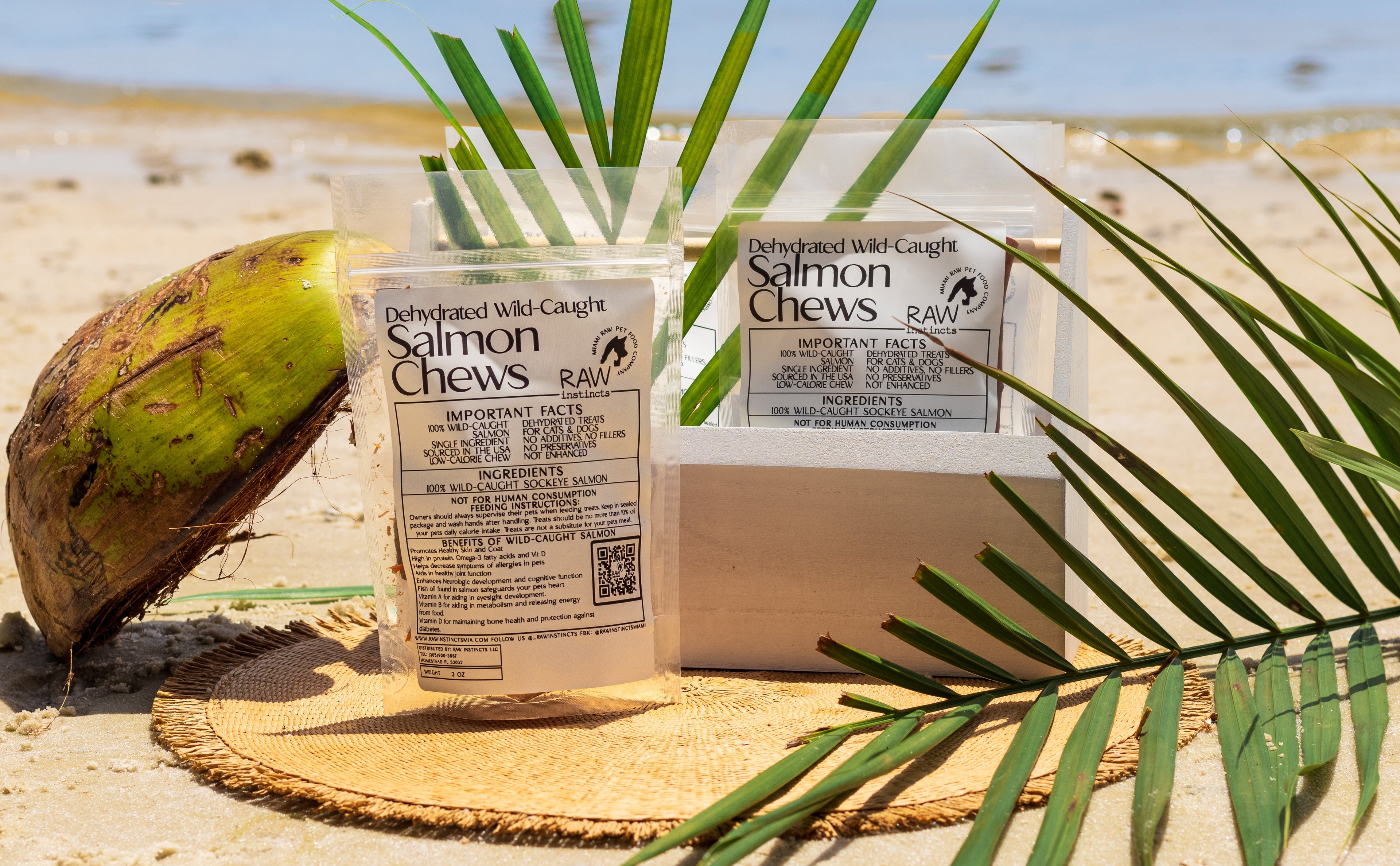 Dehydrated wild-caught salmon chews in two pouches on woven mat