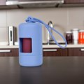 Cornflower blue waste bag dispenser with cord handle and front bag opening